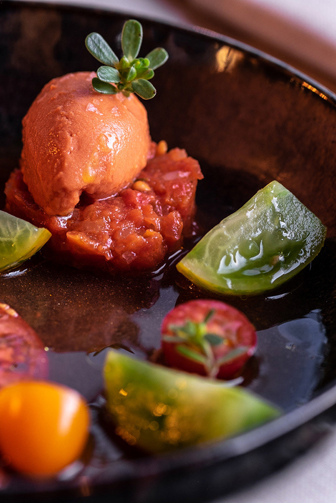 Restaurant I-Santi, four kinds of organic tomatoes, with tomato paté, a tomato sorbet, black olives and purslane shoots with a tomato water and olive oil dressing