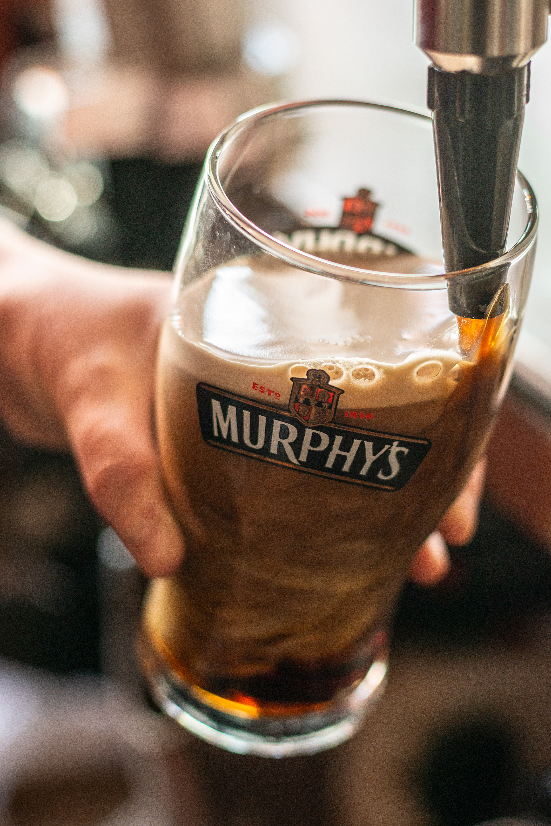 Levis's Bar - Caroline pulling a pint of Murphys stout - Ballydehob