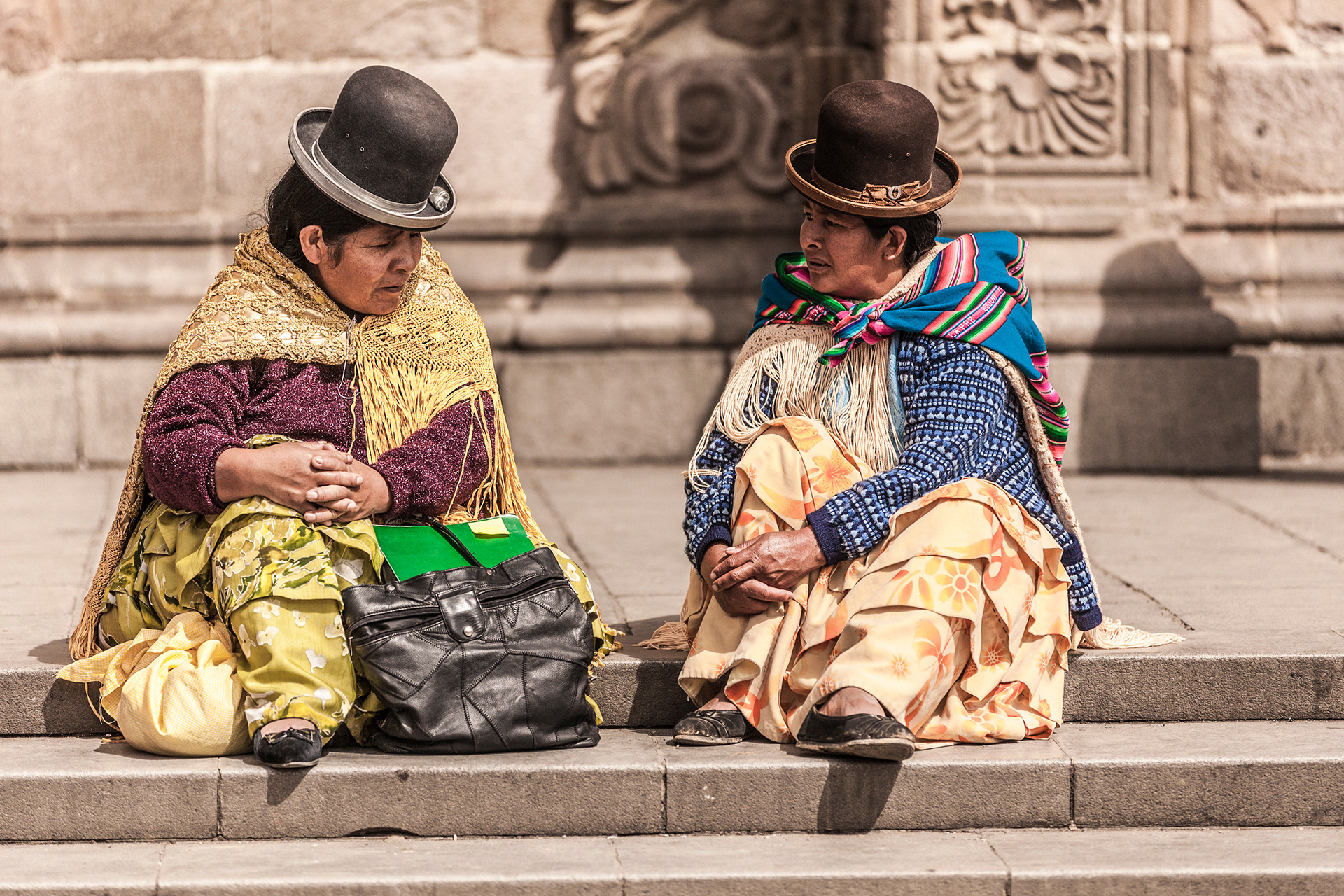 Aymara women known as cholas or cholitas, wear bowler hats slanted on the head, a long decorative skirt called a pollera or more often 2, 3 or more of them! The bowler hats (Bombín in Spanish were introduced by British railway workers in the 1920's