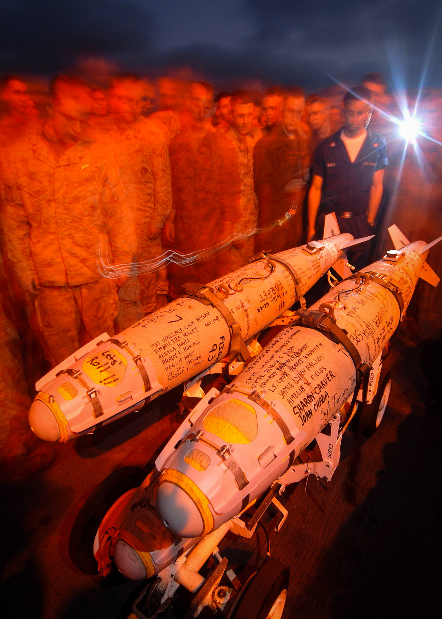 Aboard USS IWO JIMA LHD 7 (Sept. 10, 2006) -- Sailors and Marines view special ordnance bearing names of the victims of September 11th during a Captain's Call held on the flight deck aboard USS Iwo Jima (LHD 7) to commemorate the 5th anniversary.  Iwo Jima recently deployed from here homeport of Norfolk, Va., and began a regularly scheduled six-month deployment to the U.S. European Command and U.S. Central Command (CENTCOM) areas of responsibility (AOR) to conduct Maritime Security Operations (MSO)U.S. Navy photo by Mass Communications Specialist Christopher L. Clark