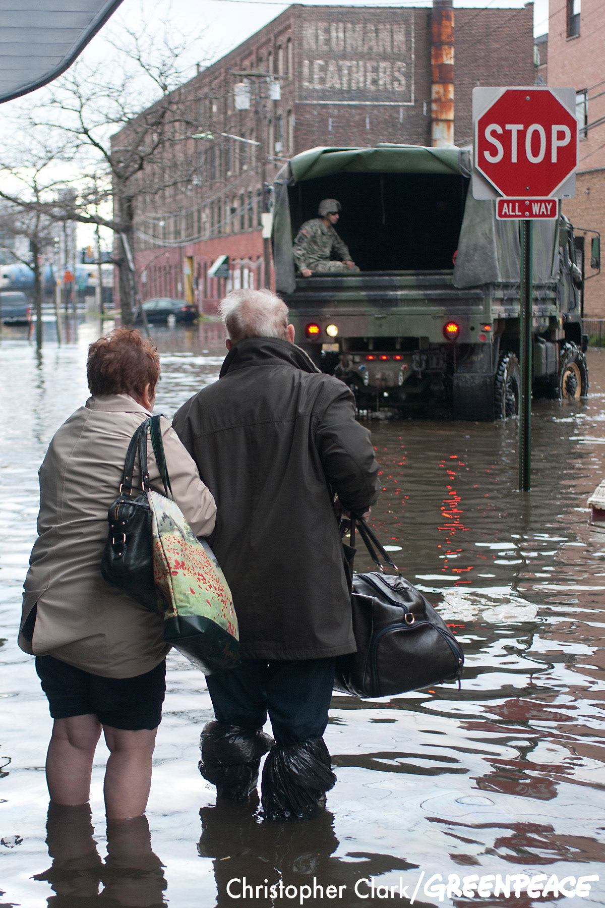 An elderly couple waits, in the flooded streets of Hoboken, New Jersey, for a National Guard truck to evacuate them to dry land in the aftermath of hurricane Sandy on October 31st, 2012.
