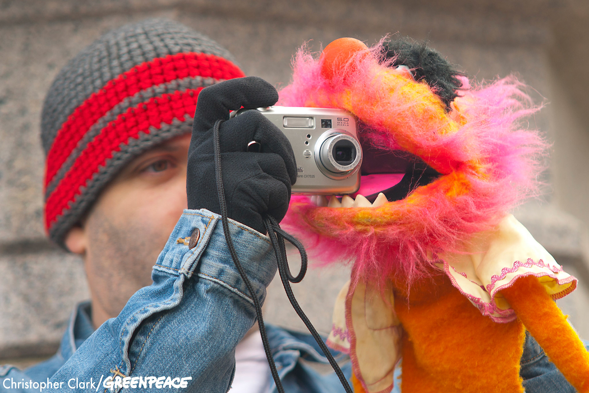 A marcher takes a picture, with the help of his puppet, in Lincoln Park the starting point for the Million Puppet March on the Washington, DC mall Nov. 3rd, 2012. The Million Puppet March, a rally against the Republican presidential candidate Mitt Romney's debate remarks about Big Bird and cutting PBS funding if elected, started in Lincoln Park and ended at a Capitol Reflecting Pool rally with an estimated 600 in attendance.