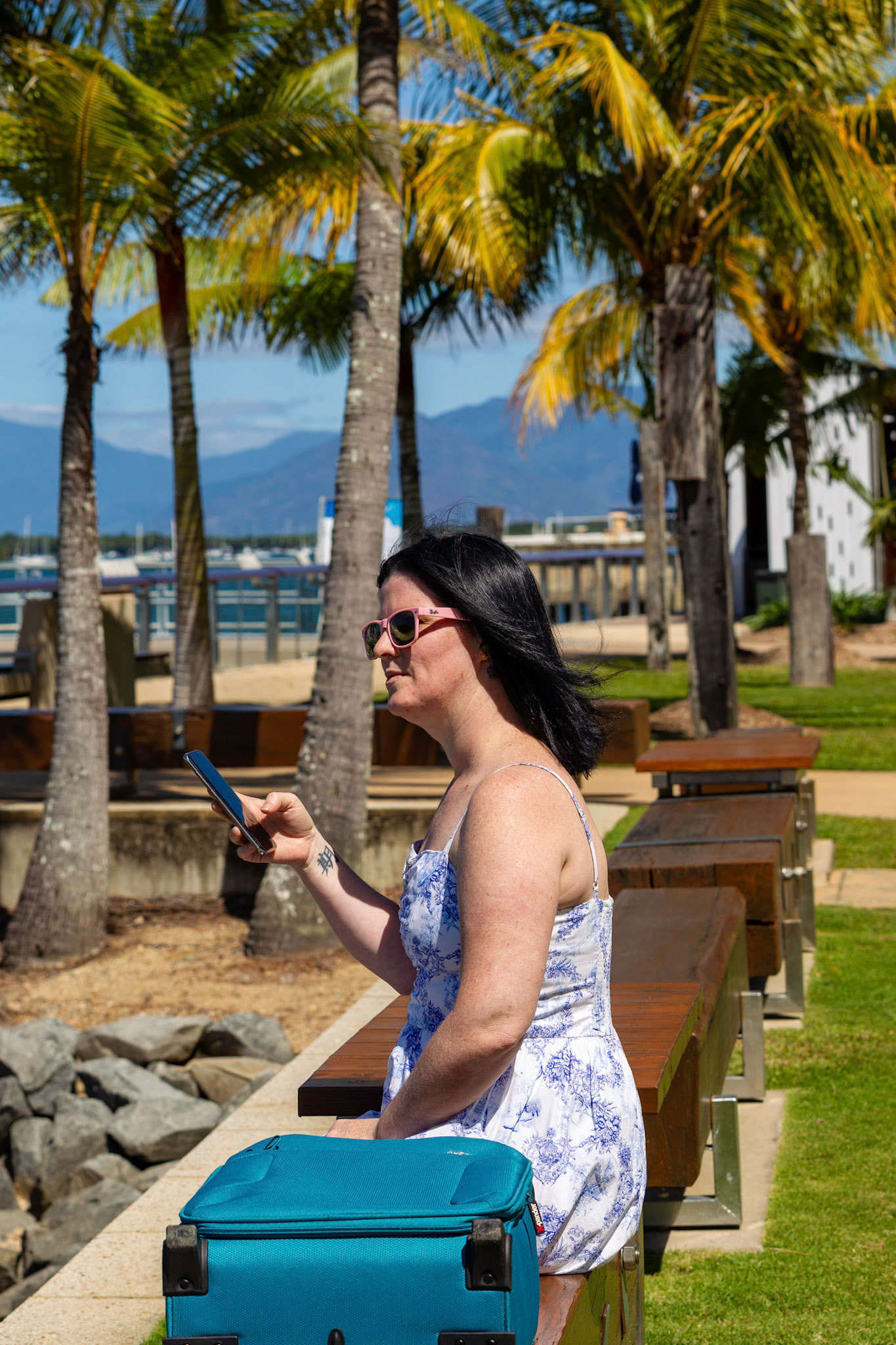 lady sitting on log holding phone side on suite case sunglasses pretty summer blue white dress  © copyright-lewis-a-collins-photographer-!http://lewiscollins.au