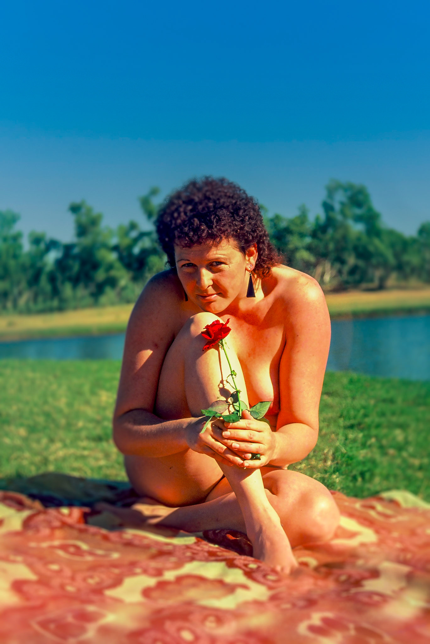 woman rose enjoying sunshine at lake
