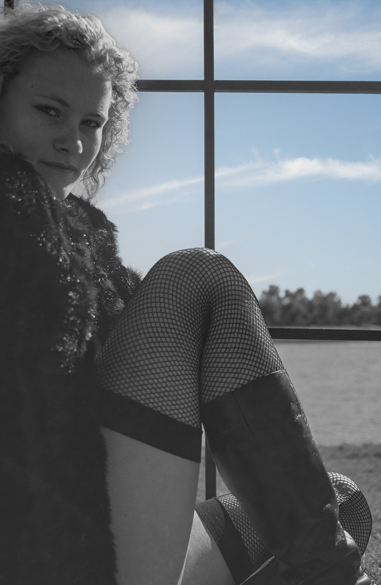 young lady black fur jacket at window
