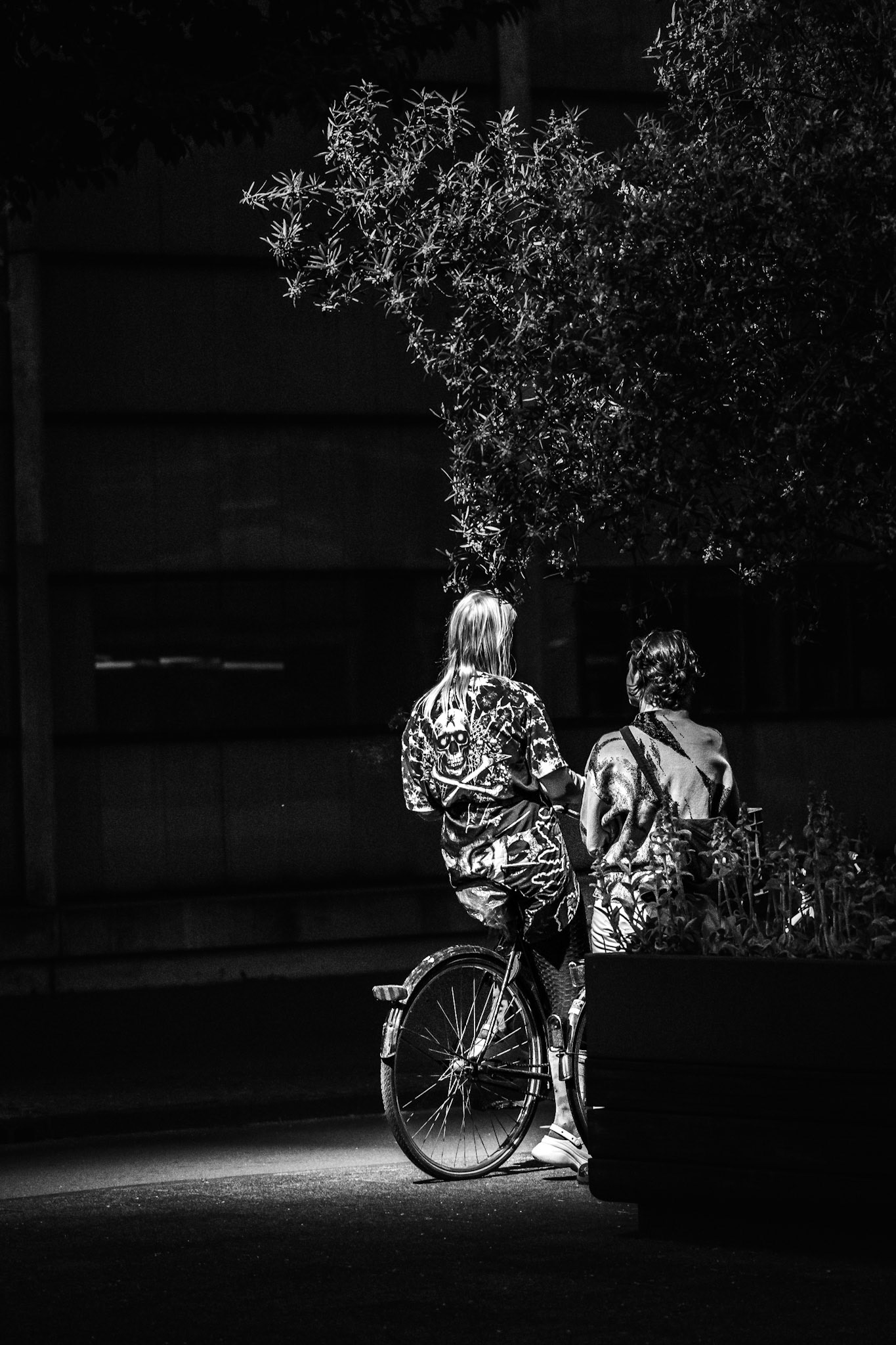 Two women illuminated by a street light in Amsterdam