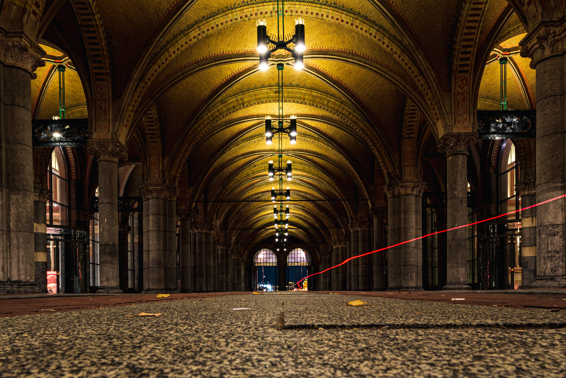 The brake light of a passing cycling underneath the Rijksmuseum.