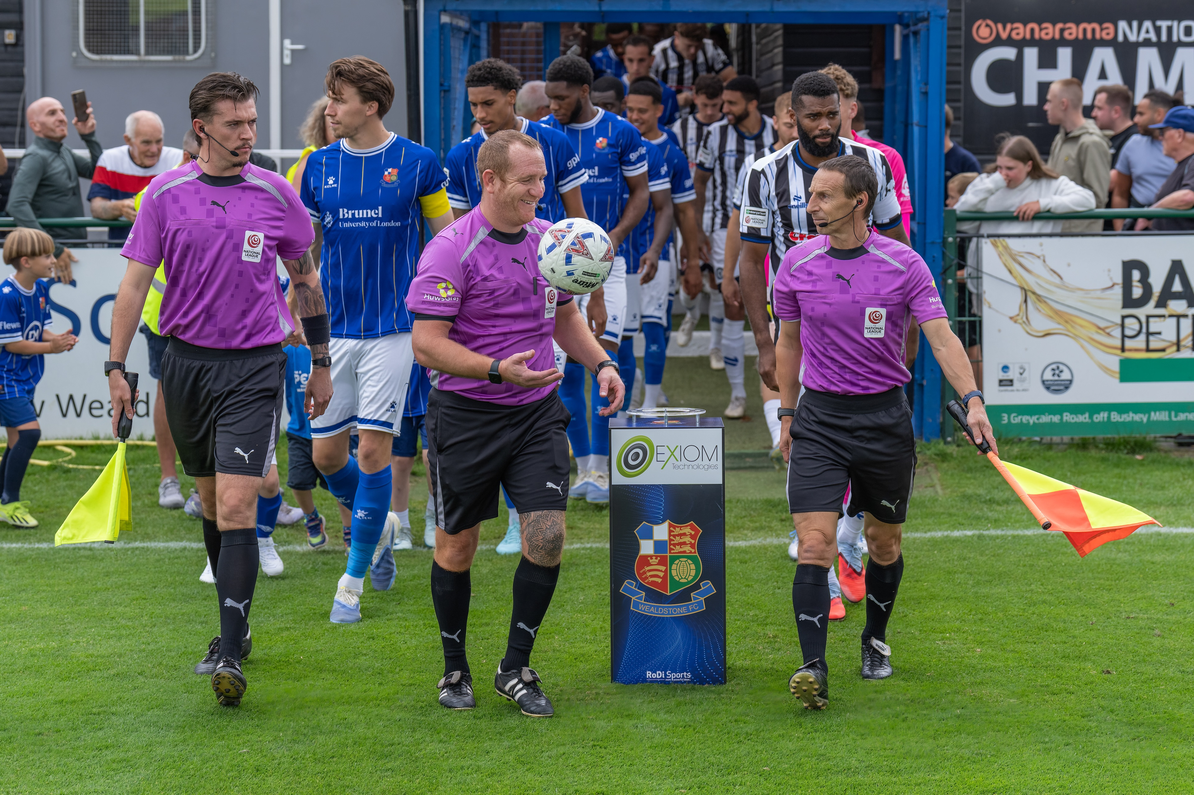 Officials lead out the teams