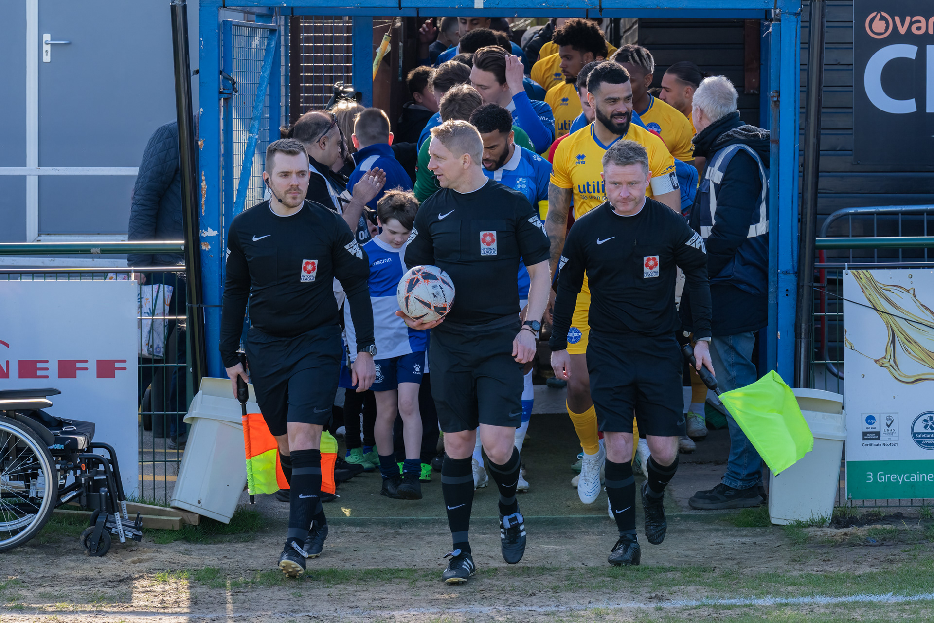 Officials lead out the teams