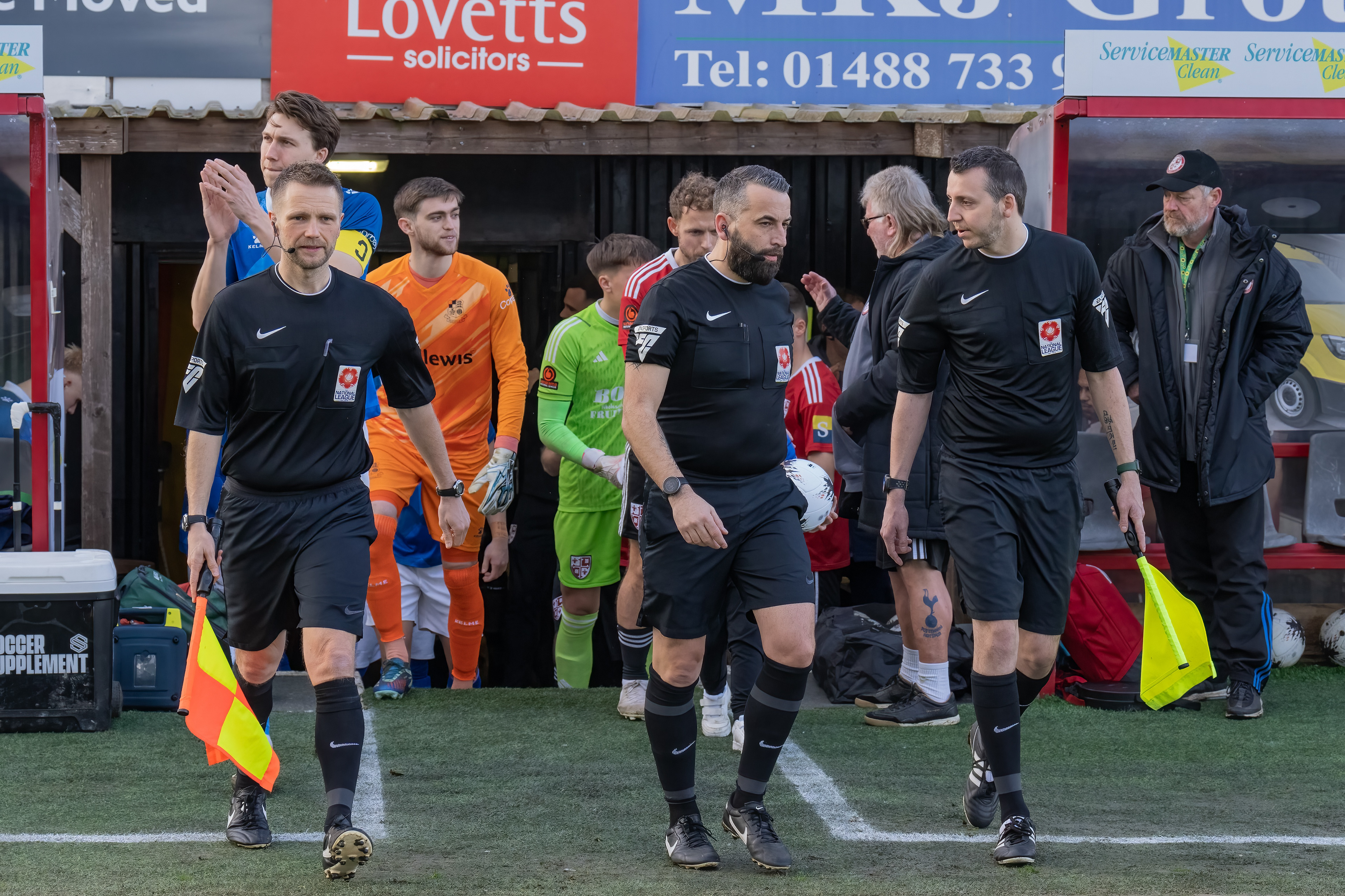 Officials lead out the teams