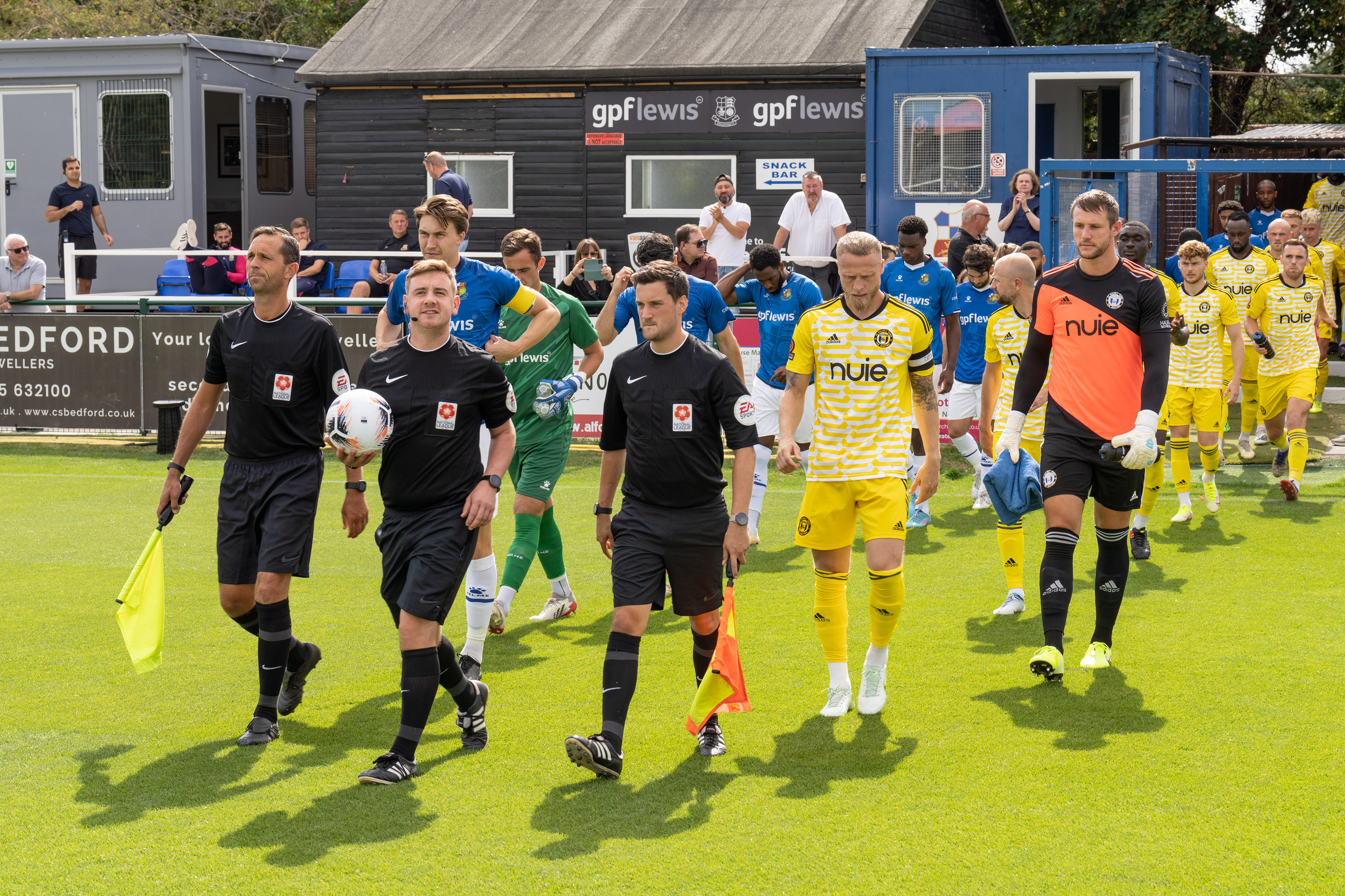 Officials lead the teams out