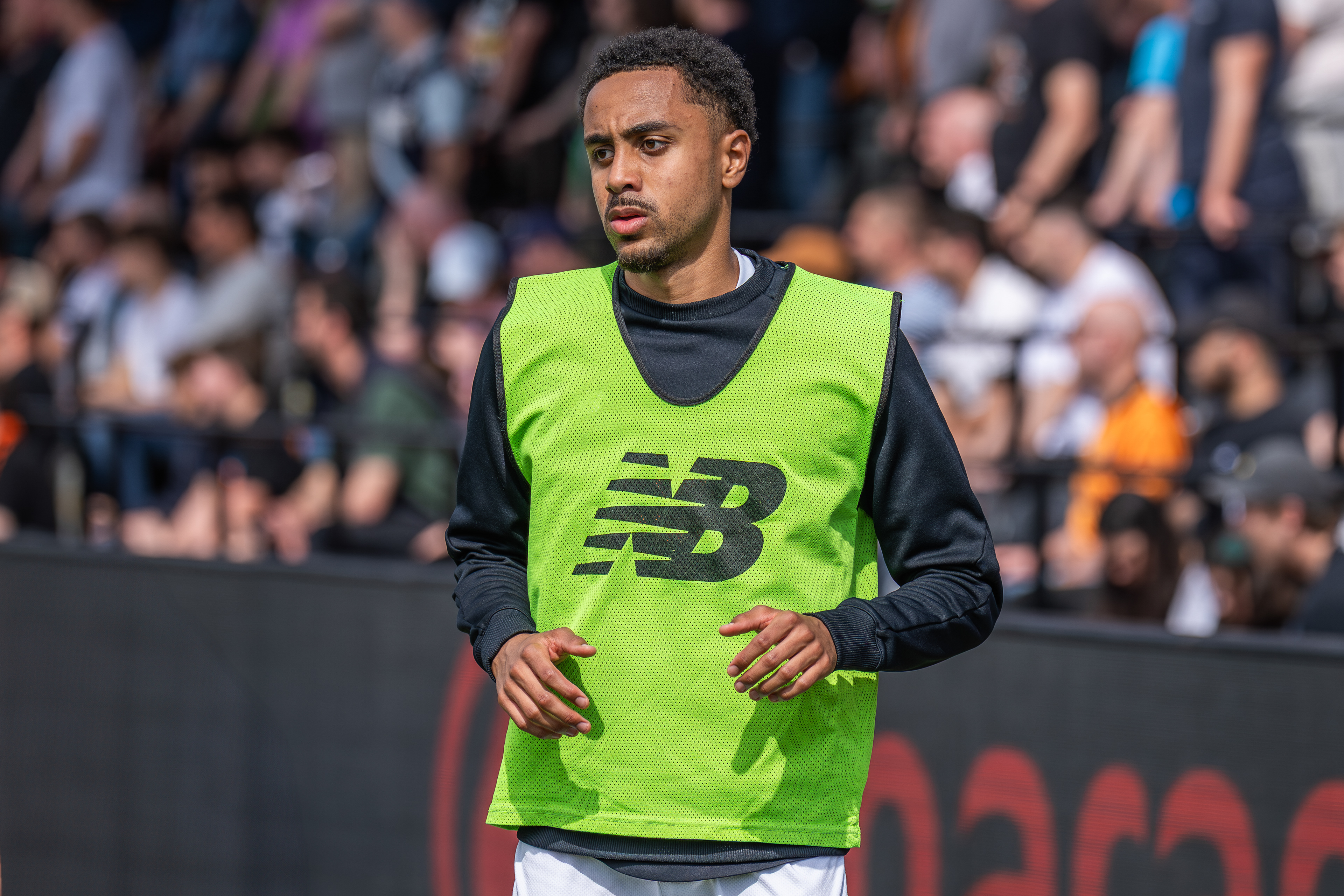 Harrison Sohna warming up on the touchline