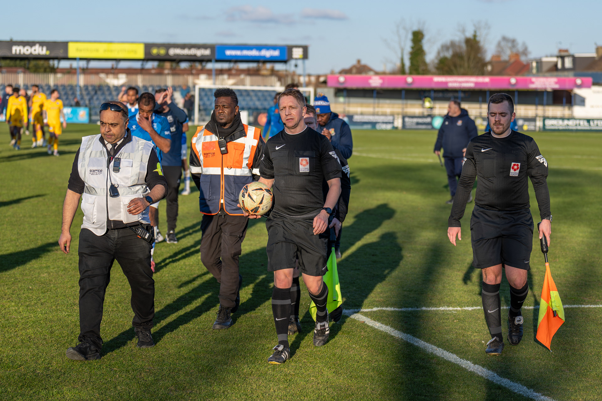 Officials leave the pitch