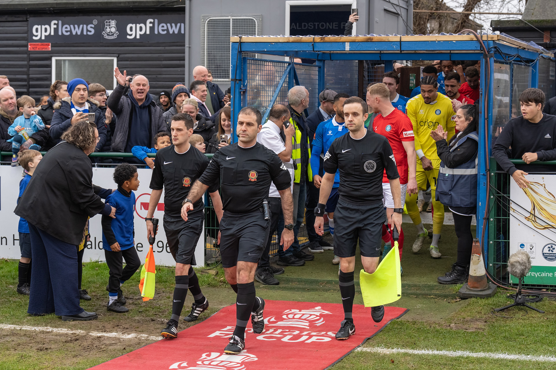 Officials lead out the teams