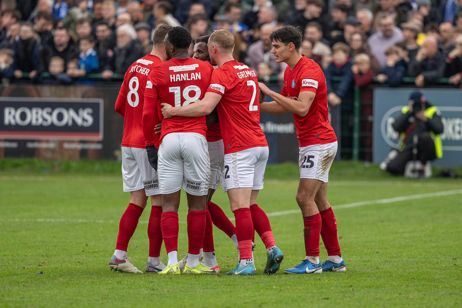 ....and is mobbed by jubilant teammates