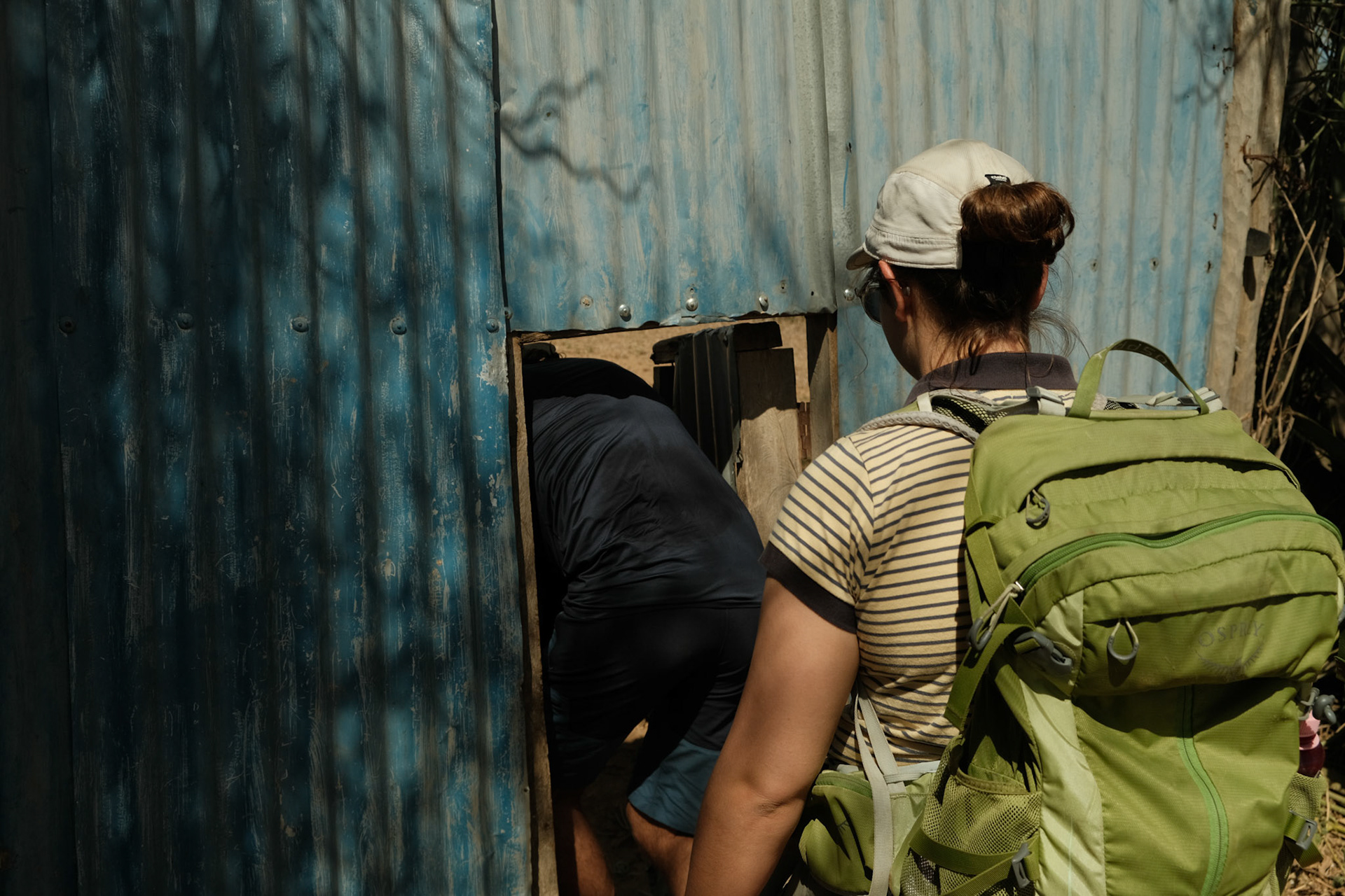 AFSS students entering a farmer's house to interview.