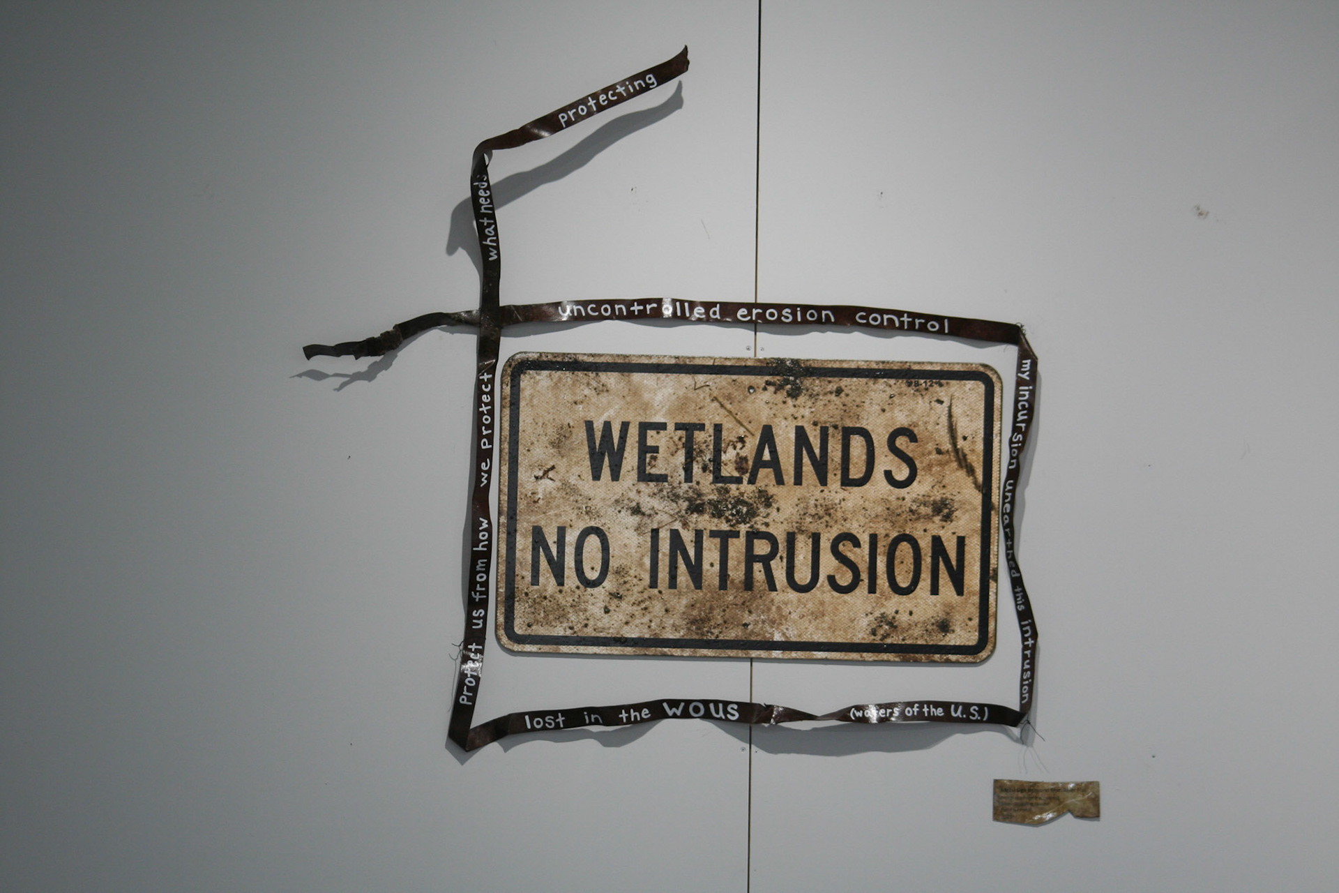 "Metal Sign Intrusion from River Flat"