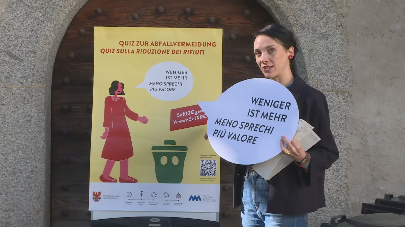 Mayor of Merano Katharina Zeller in front of the poster of the campaign 