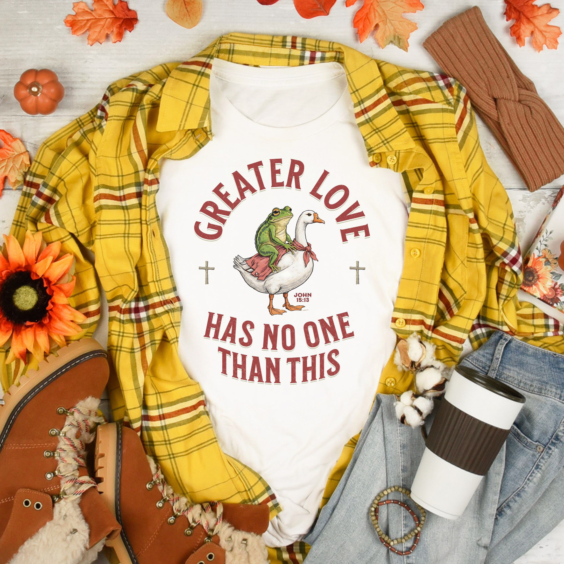 Fall women's outfit featuring a mustard and burgundy flannel shirt and t-shirt that says Greater Love Has No One Than This (John 15:13) and a frog riding a goose