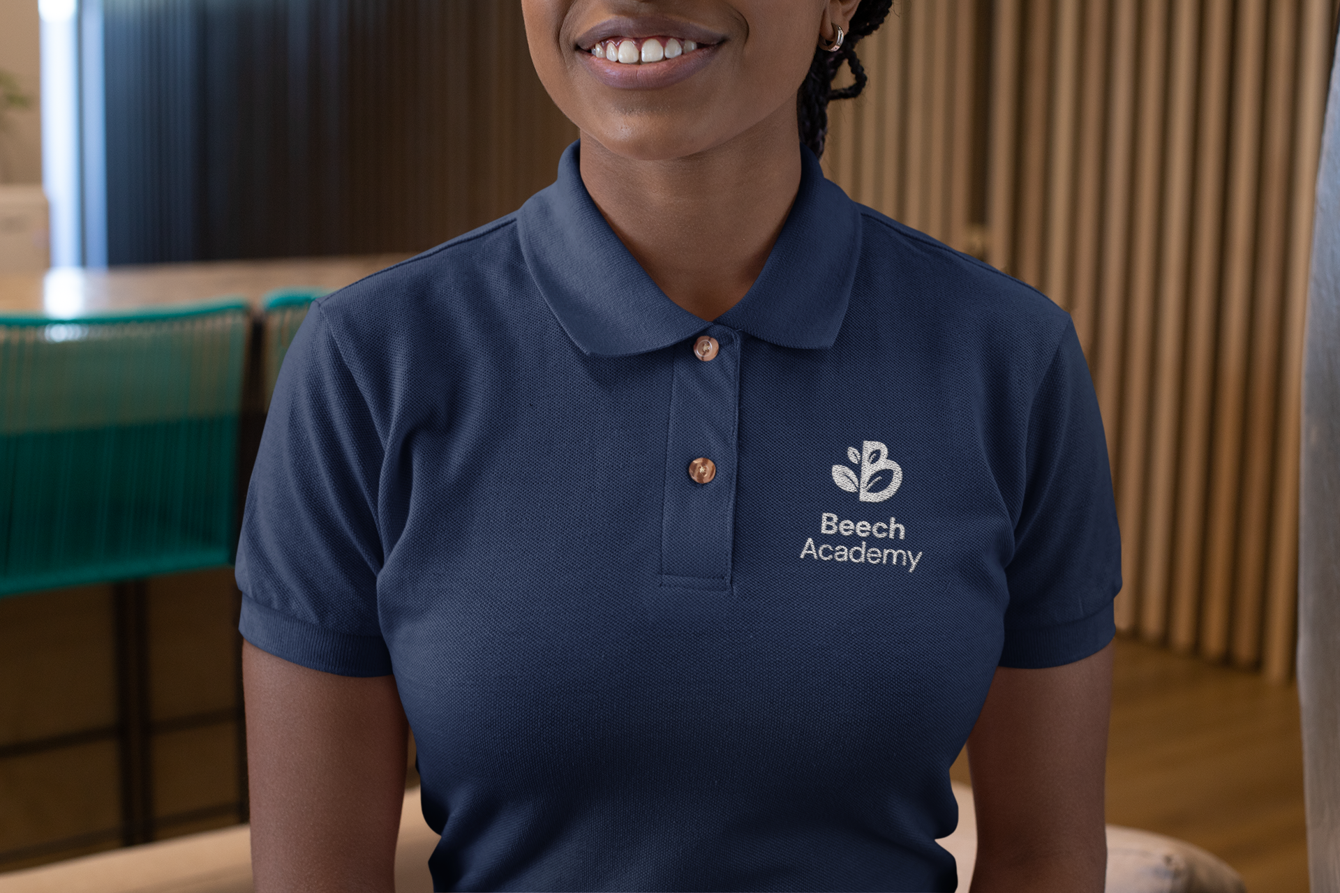 Image of girl with navy blue polo shirt with Beech Academy logo embroidered on her top right chest