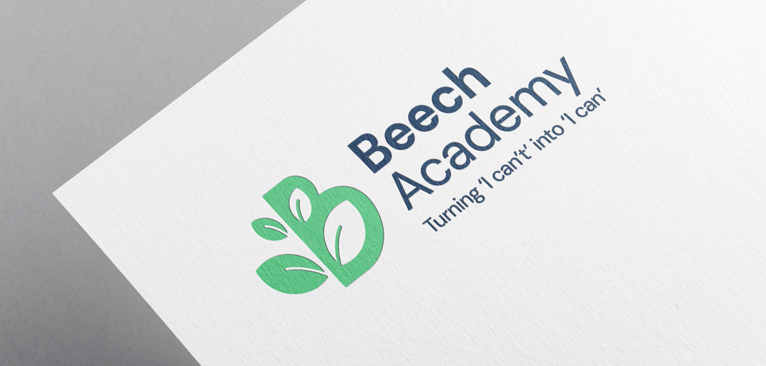 Beech Academy logo green and navy with the strapline Turning I Can't into I Can underneath on paper