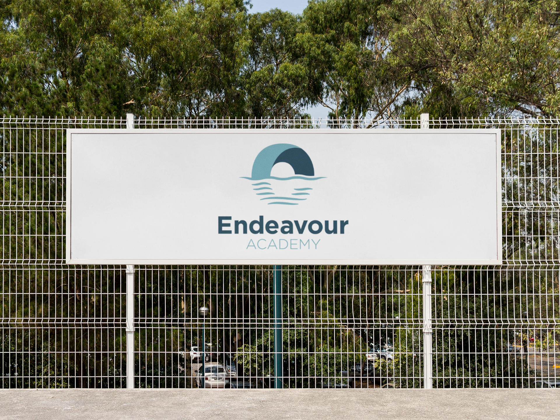 endeavour academy logo on a sign against a fence