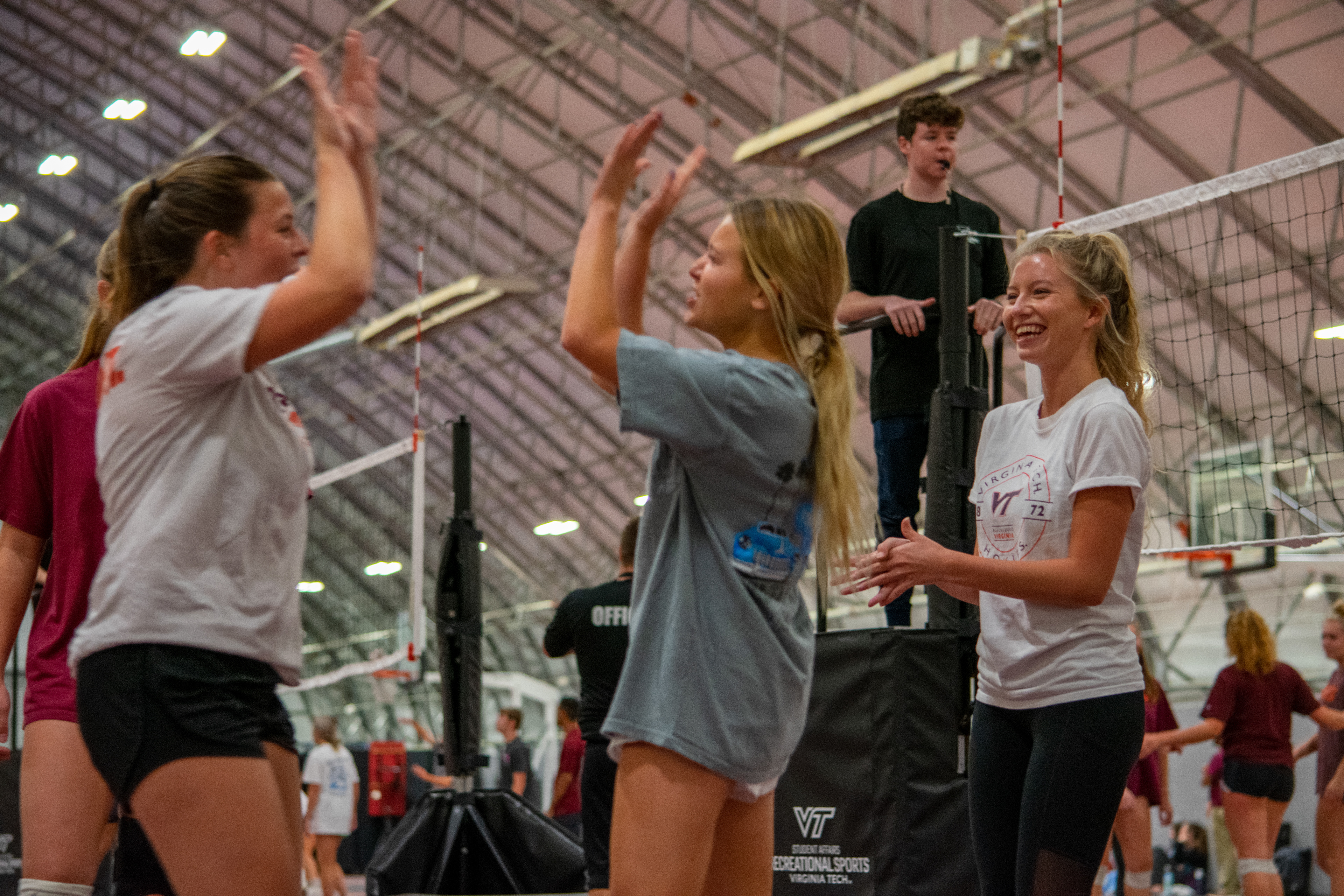 Team members on the "Foxridge Girls" intramural volleyball team at Virginia Tech, celebrating after scoring the winning point to end the game on October 26th, 2021 in Blacksburg, VA.