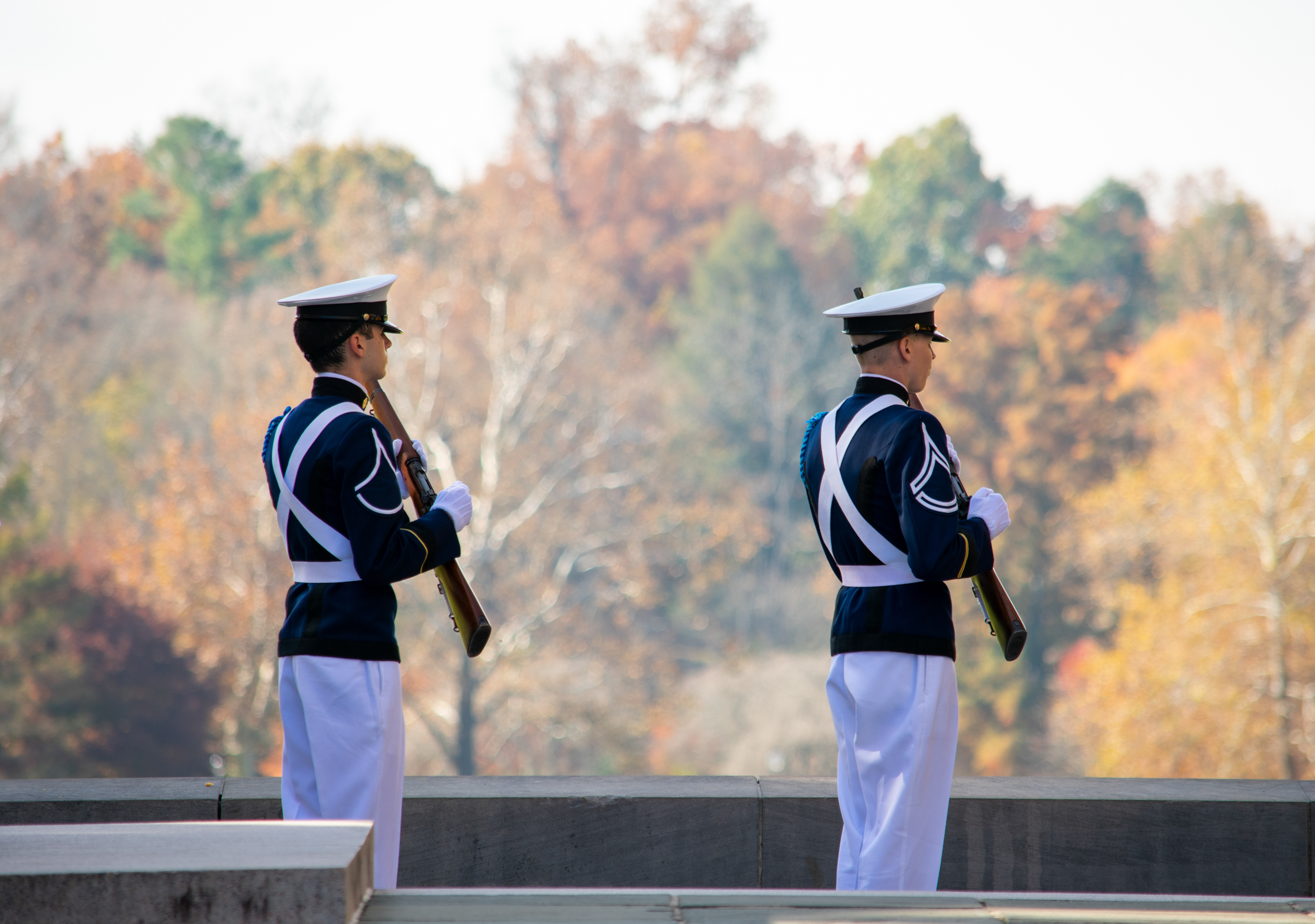 Two officers of The Gregory Guard, the Corps of Cadets precision rifle drill team, firing a rifle salute at the Virginia Tech Veterans Day remembrance ceremony on November 11, 2021.
