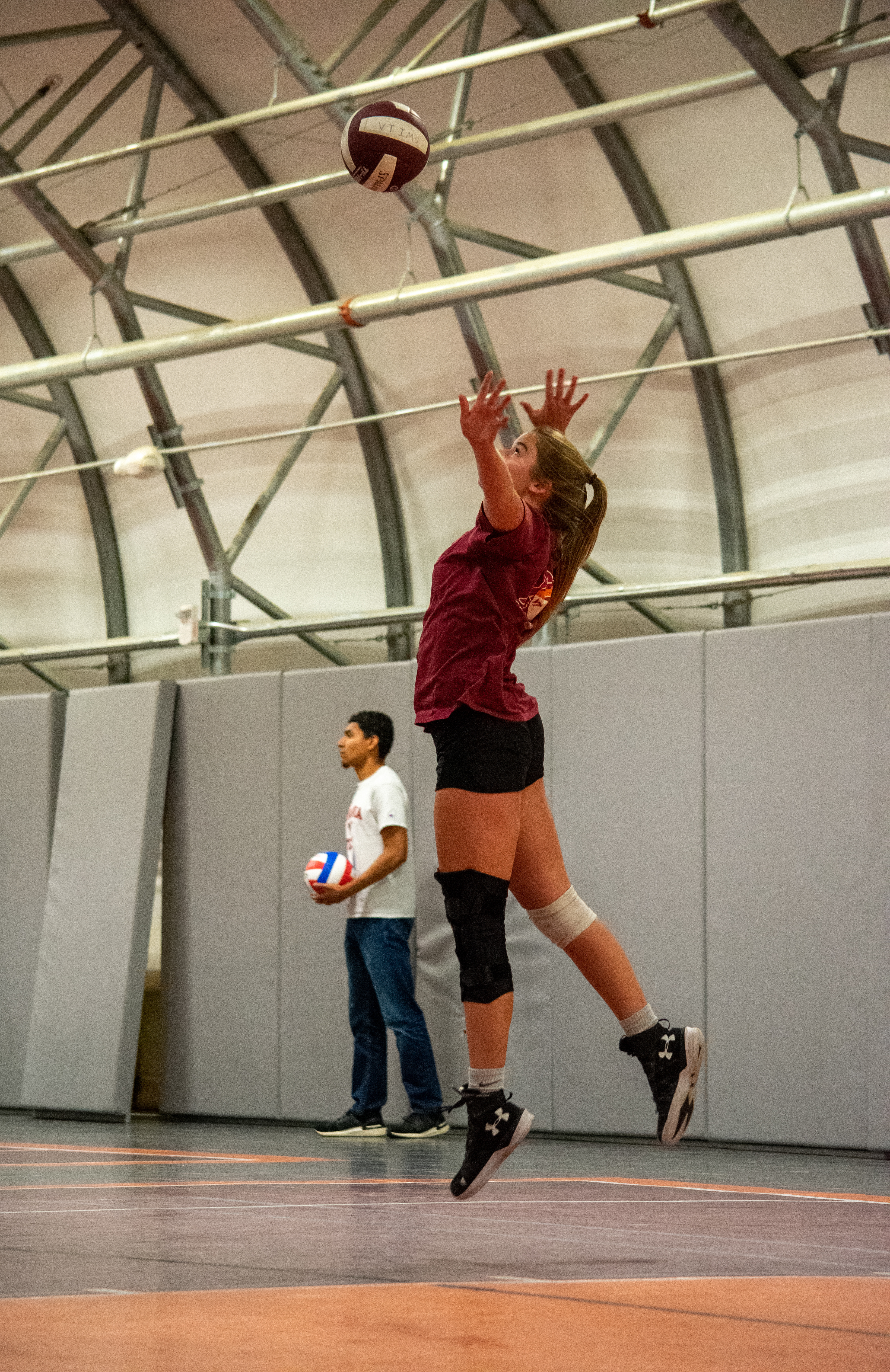 A freshman on the "Foxridge Girls" team getting airborne while serving the ball at the Virginia Tech intramural volleyball game on October 26th, 2021 in Blacksburg, VA.