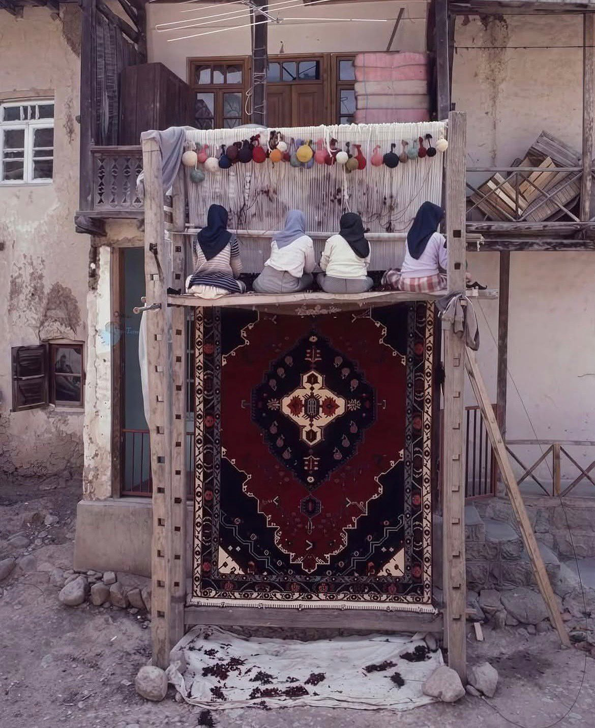 Women weaving Persian carpets by hand, Kashan, Iran, 1989