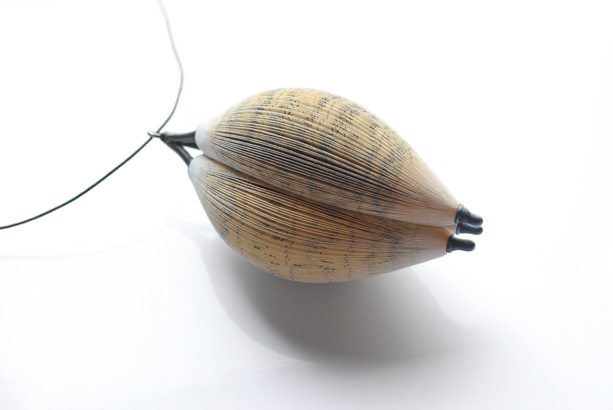 Pendant, 2011; paper, cashew paint, silver