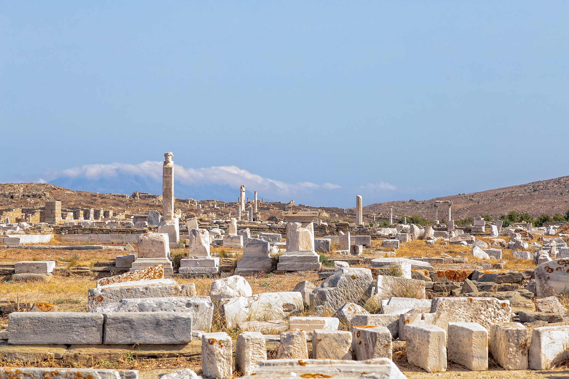 Delos, Greece - May 22nd 2018: Ancient ruins scatter the landscape, remnants of a once-thriving civilization, now a historical site attracting visitors and researchers.