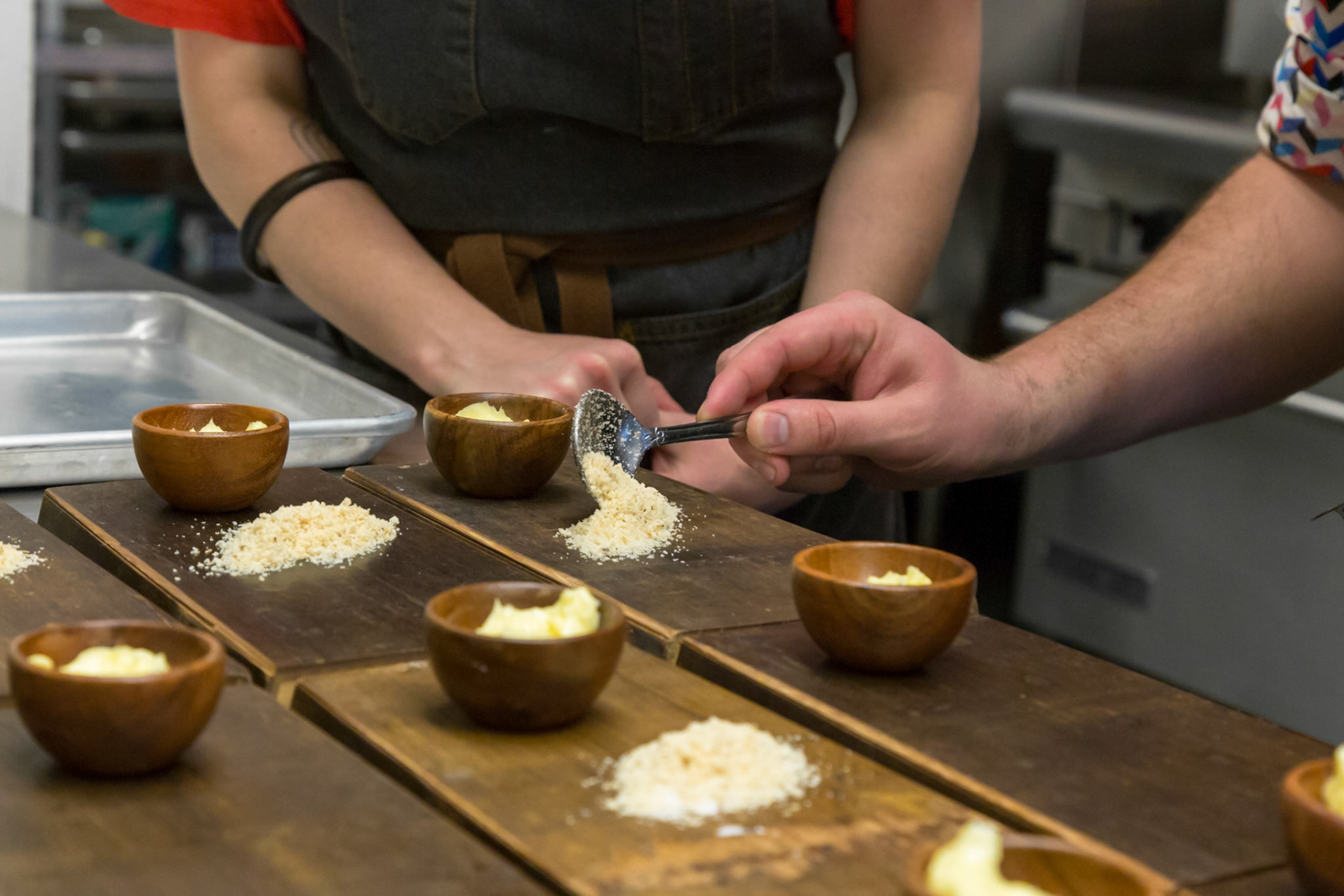 Fog Lark, Portland, Oregon - April 6th 2018: Chefs plating appetizers with butter and breadcrumbs for a tasting menu at a restaurant.