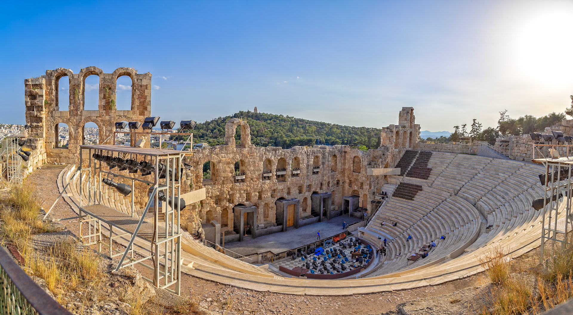 Acropolis, Athens, Greece - May 23rd 2018: The Odeon of Herodes Atticus, an ancient Roman theatre, is being prepared for a performance with chairs and lighting.