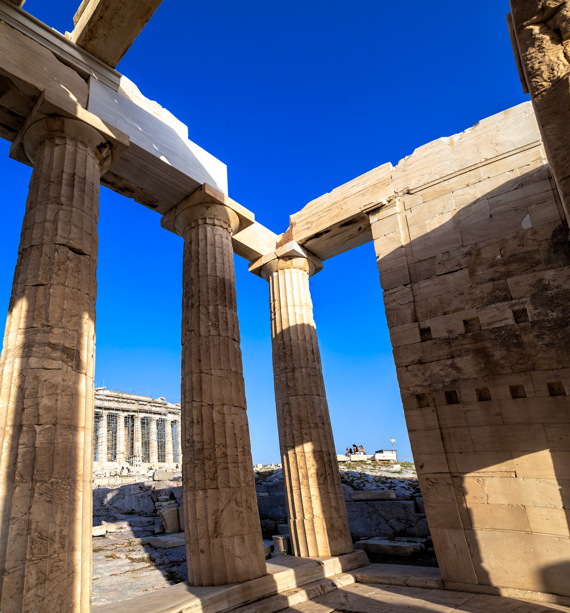 Acropolis, Athens, Greece - May 23rd 2018: Tourists visit the Erechtheion, an ancient Greek temple on the north side of the Acropolis, dedicated to Athena and Poseidon.