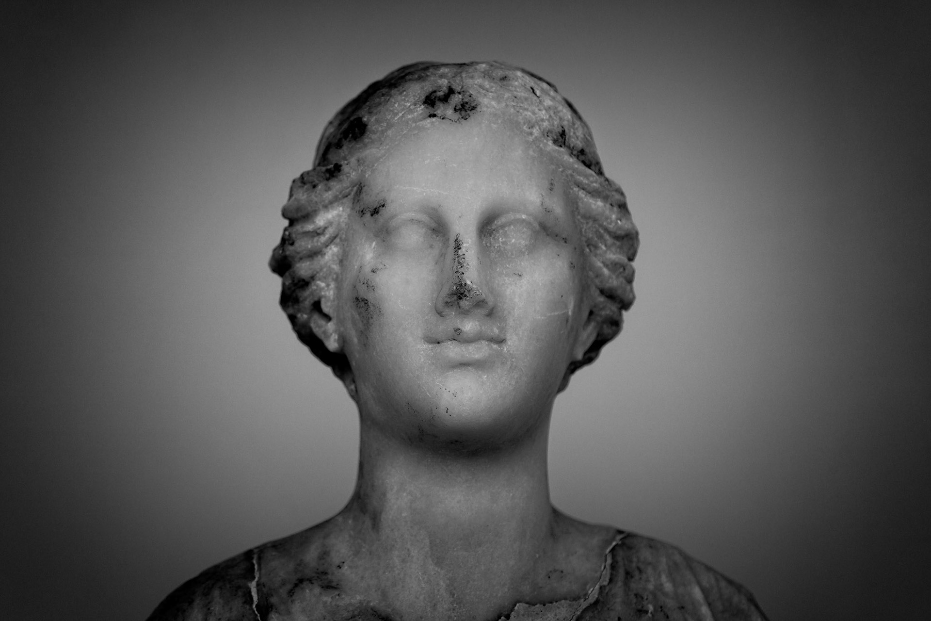 Delos, Greece - May 22nd 2018: A marble bust of a woman, possibly a goddess, stands as a testament to ancient Greek artistry and religious beliefs.