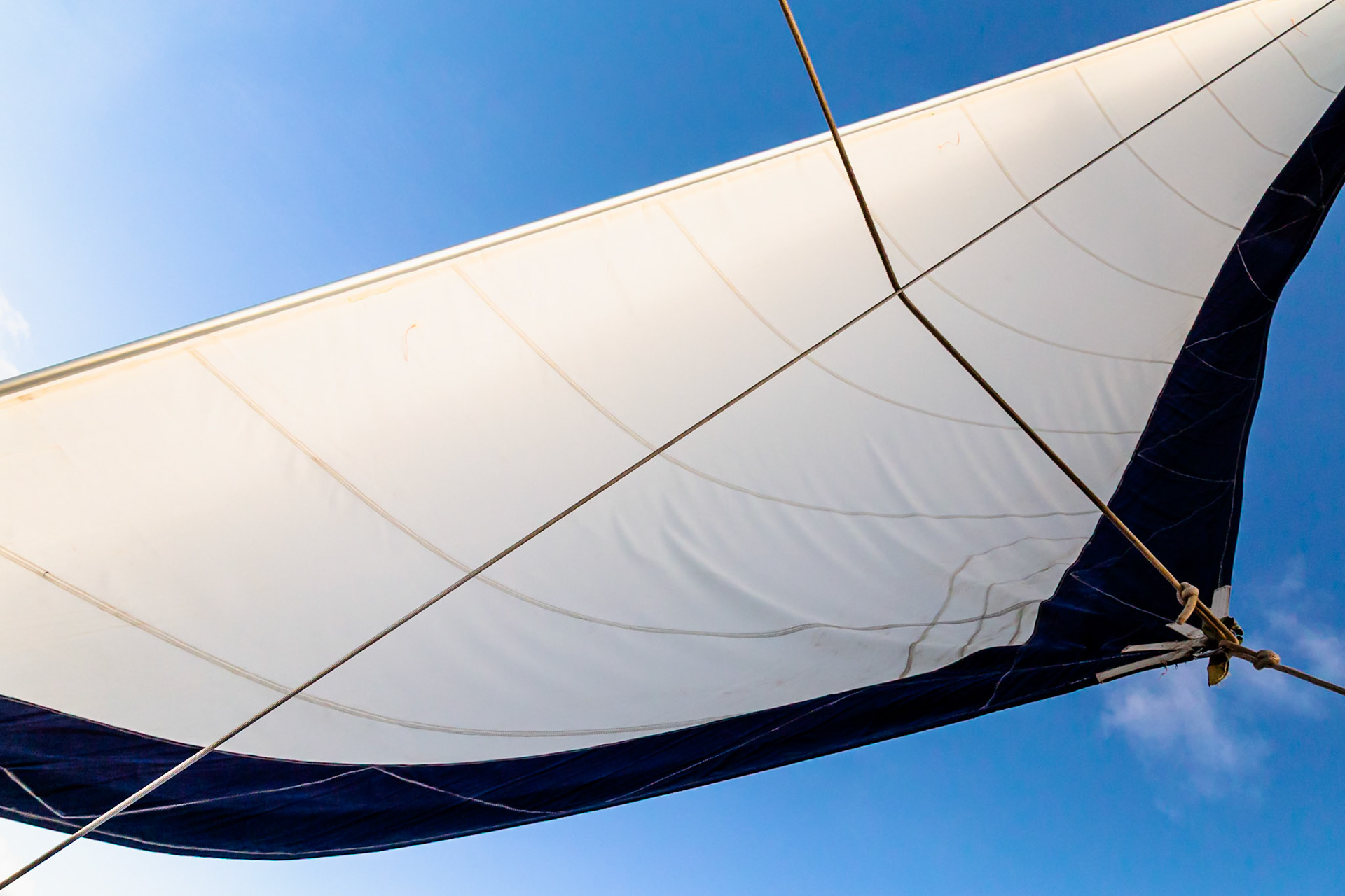 Maui, Hawaii, USA - April 7th 2022: A sailboat's sail is catching the wind, propelling the vessel forward on the water.