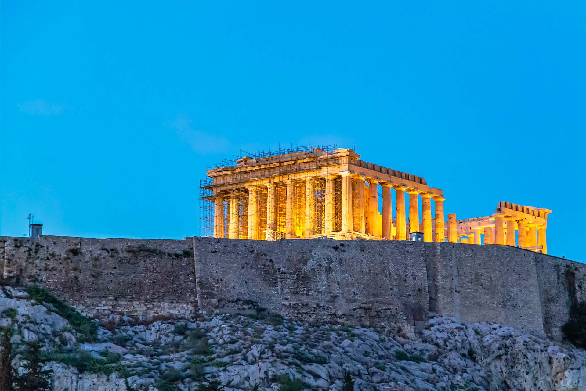 Acropolis, Athens, Greece - May 23rd 2018: The Parthenon is illuminated at night, undergoing restoration to preserve its ancient architecture.