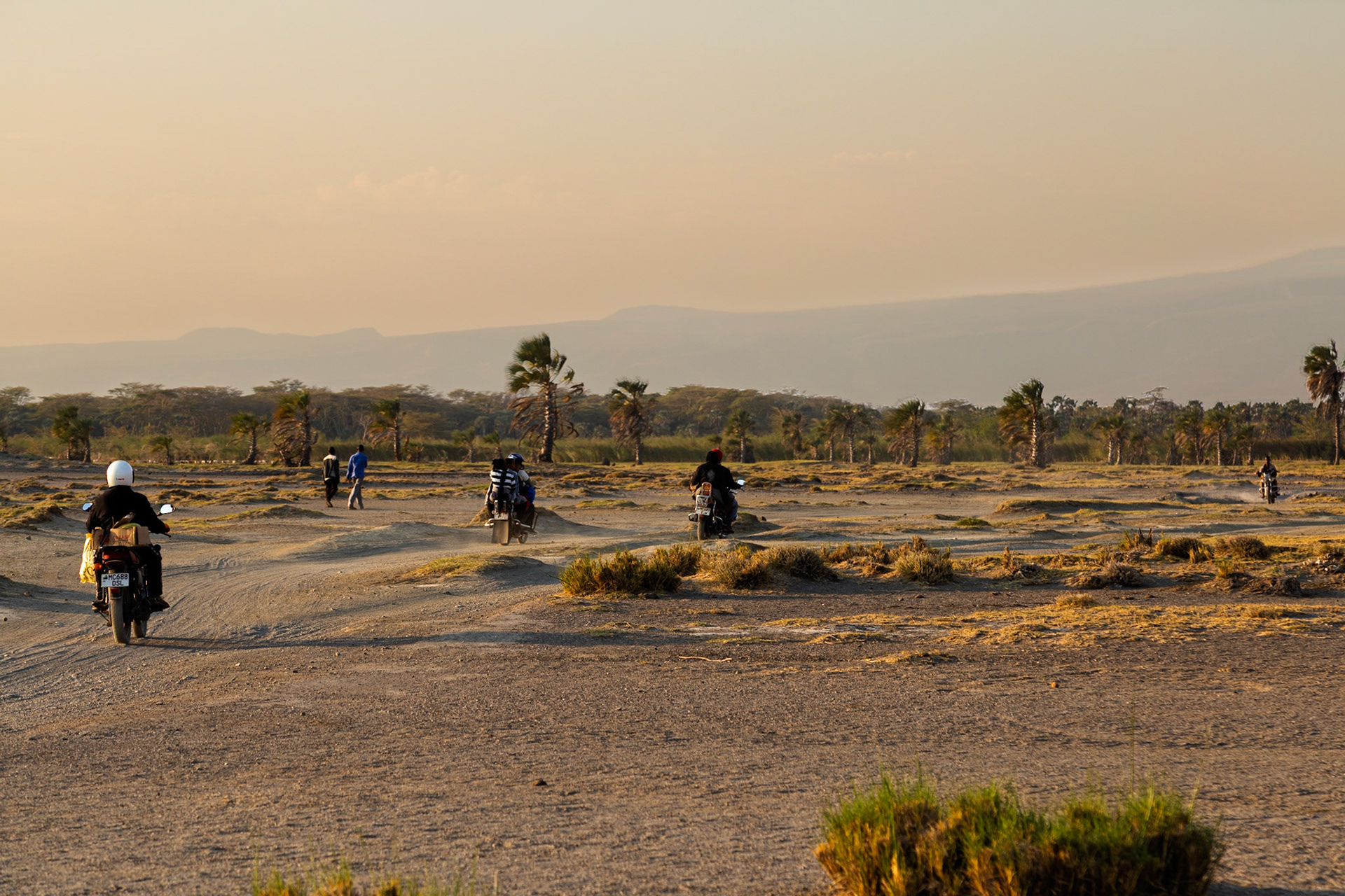 Lake Eyasi, Tanzania - September 27th 2025: Motorcyclists traverse a dusty landscape near Lake Eyasi, Tanzania.