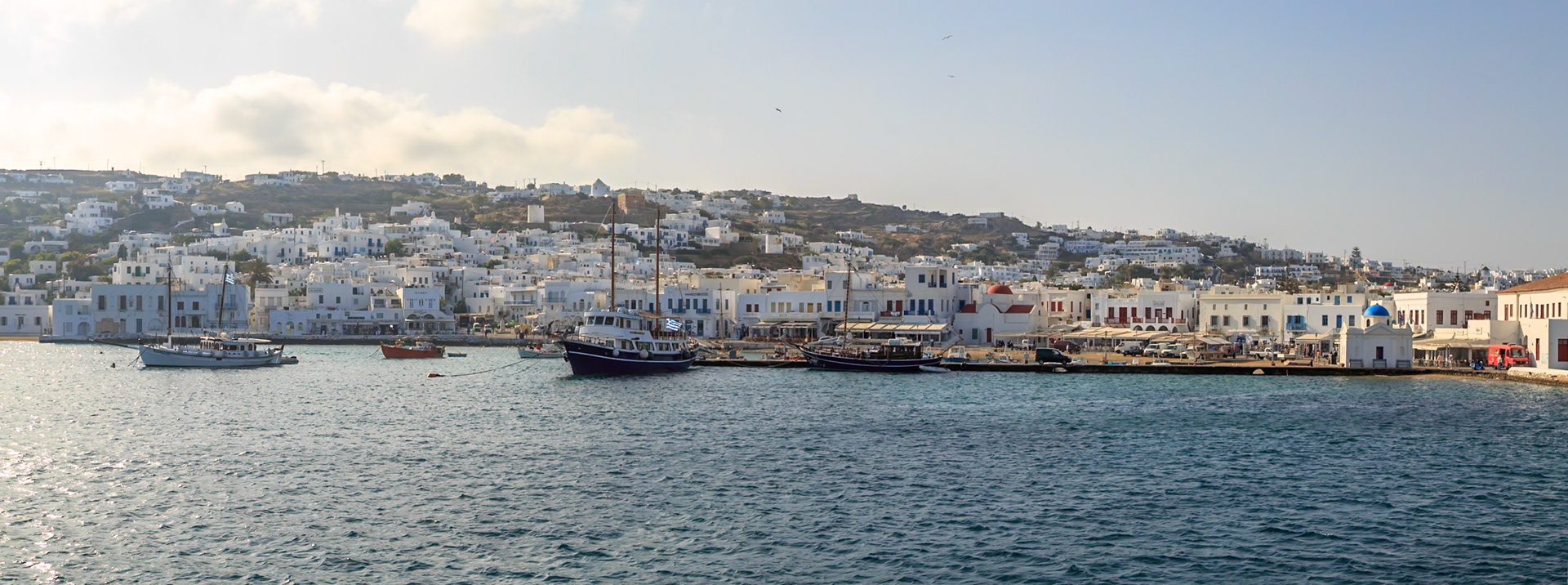 Mykonos, Greece - May 23rd 2018: Boats are docked along the harbor of Mykonos, offering scenic views and transportation for tourists.