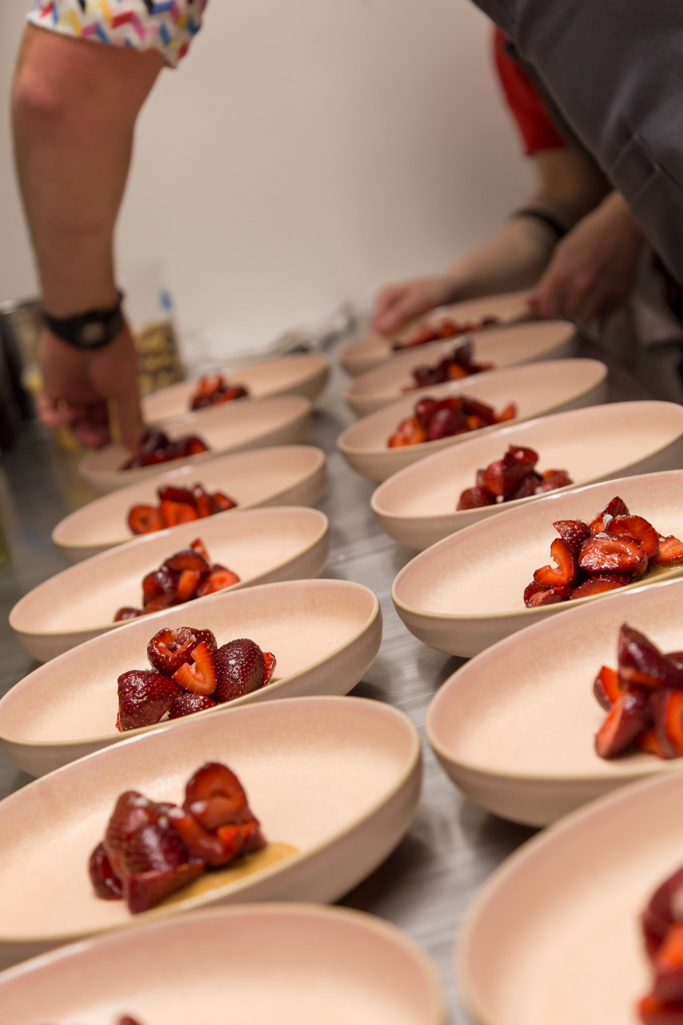 Fog Lark, Portland, Oregon - April 6th 2018: Chefs plate strawberry desserts, ensuring each dish is perfect for diners.