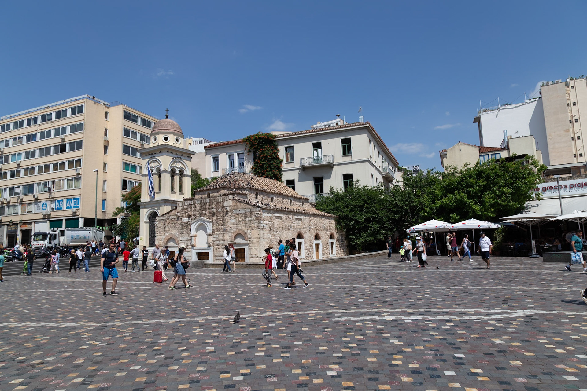 Athens, Greece - May 23rd 2018: People walk around the Church of Agioi Theodoroi, a Byzantine-era church, in Kotzia Square, Athens, Greece.