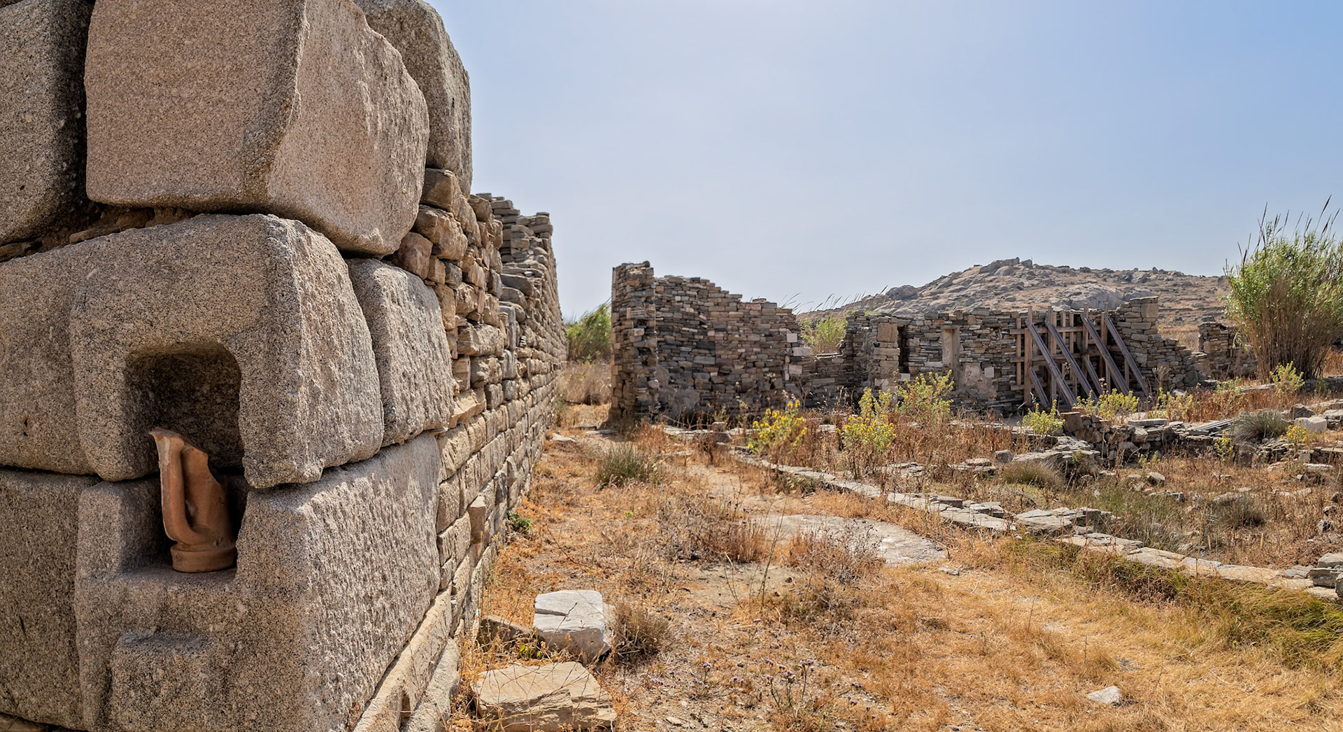 Delos, Greece - May 22nd 2018: Ancient ruins stand as a testament to Delos's rich history, showcasing the island's significance in Greek mythology and trade.