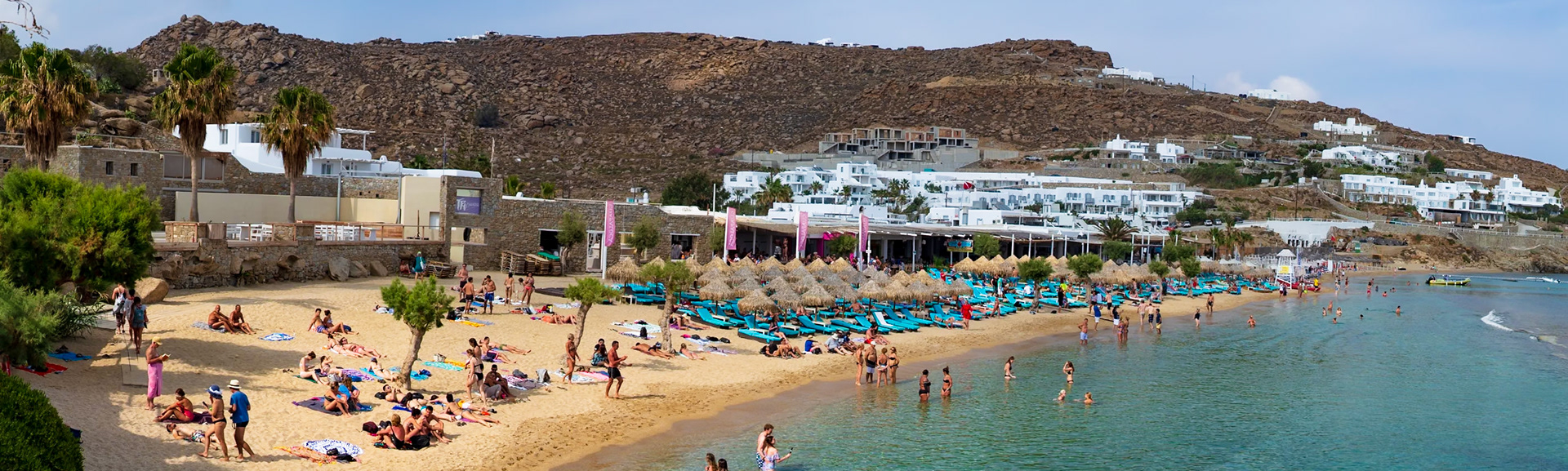 Paradise Beach, Mykonos, Greece - May 24th 2018: Beachgoers relax and swim at the popular Paradise Beach, enjoying the sun and sea.