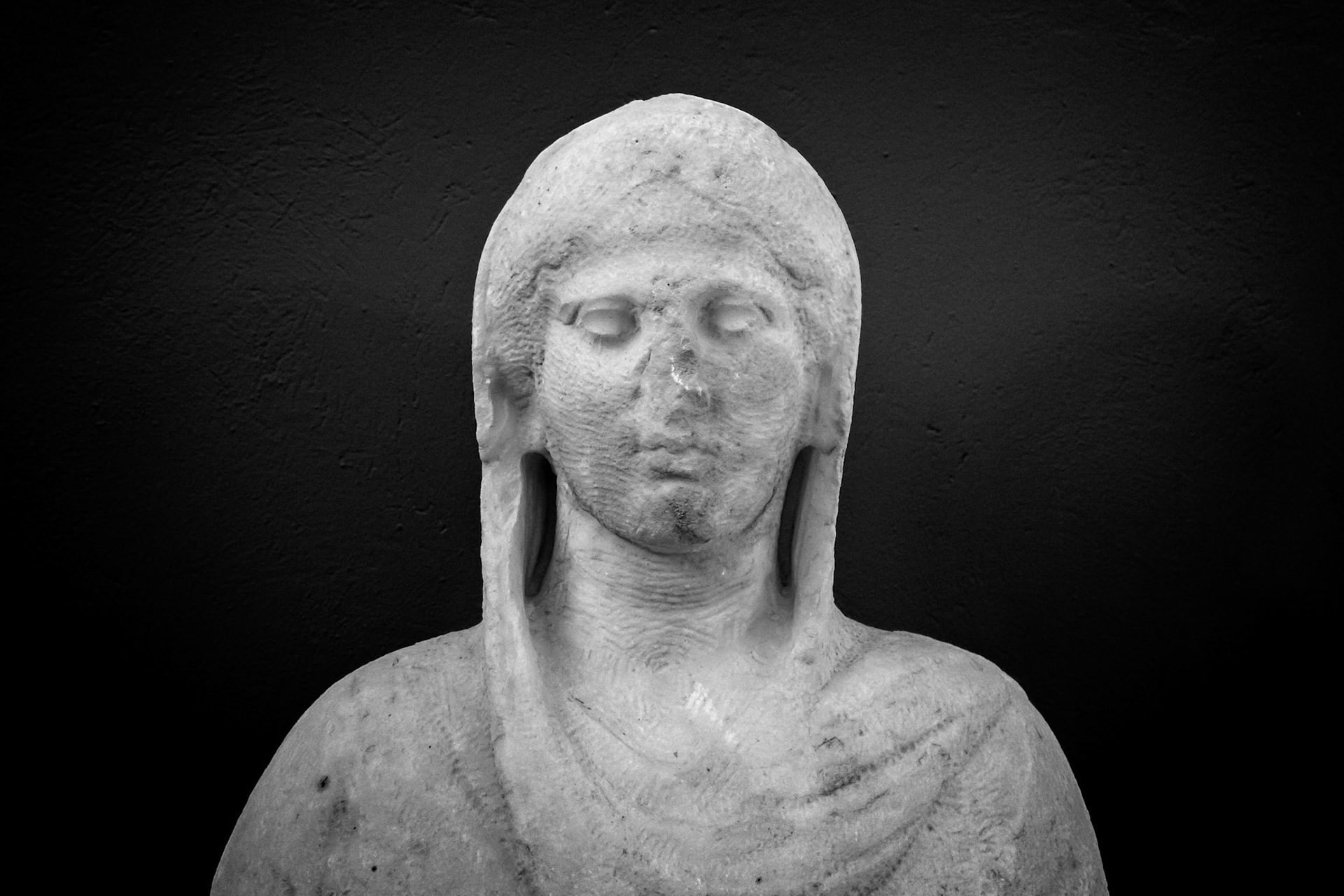 Delos, Greece - May 22nd 2018: A marble statue of a woman stands serenely. The statue is on display to preserve the history of the island.