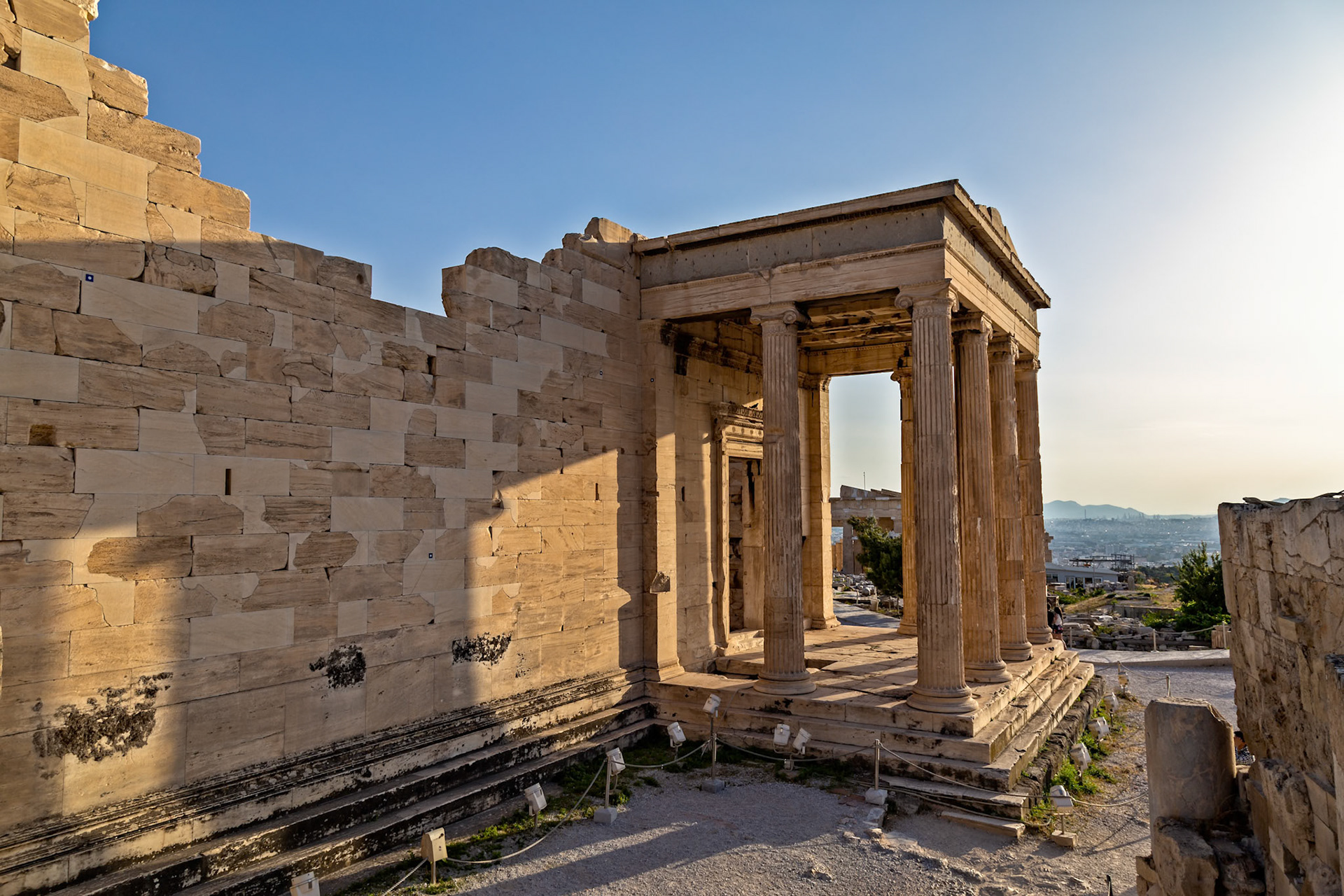 Acropolis, Athens, Greece - May 23rd 2018: Tourists explore the Erechtheion, an ancient Greek temple on the north side of the Acropolis, taking photos.