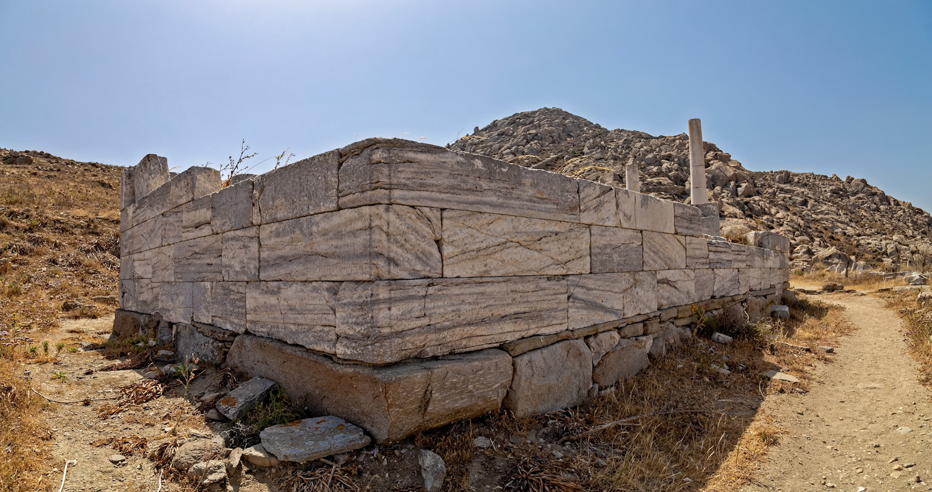 Delos, Greece - May 22nd 2018: An ancient stone structure stands on Delos, a Greek island and archaeological site. It's a reminder of the island's rich history and cultural significance.