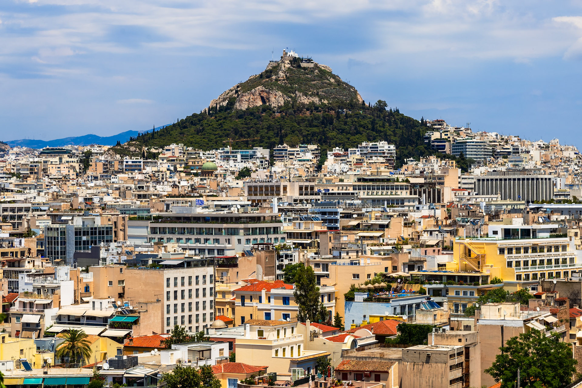 Athens, Greece - May 23rd 2018: A panoramic view of Athens shows the dense urban landscape and Mount Lycabettus, a popular tourist destination.