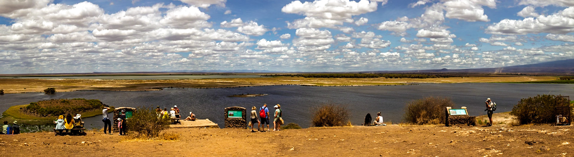 Tourists visit Amboseli National Park in Kenya to view the landscape and wildlife from a scenic overlook.