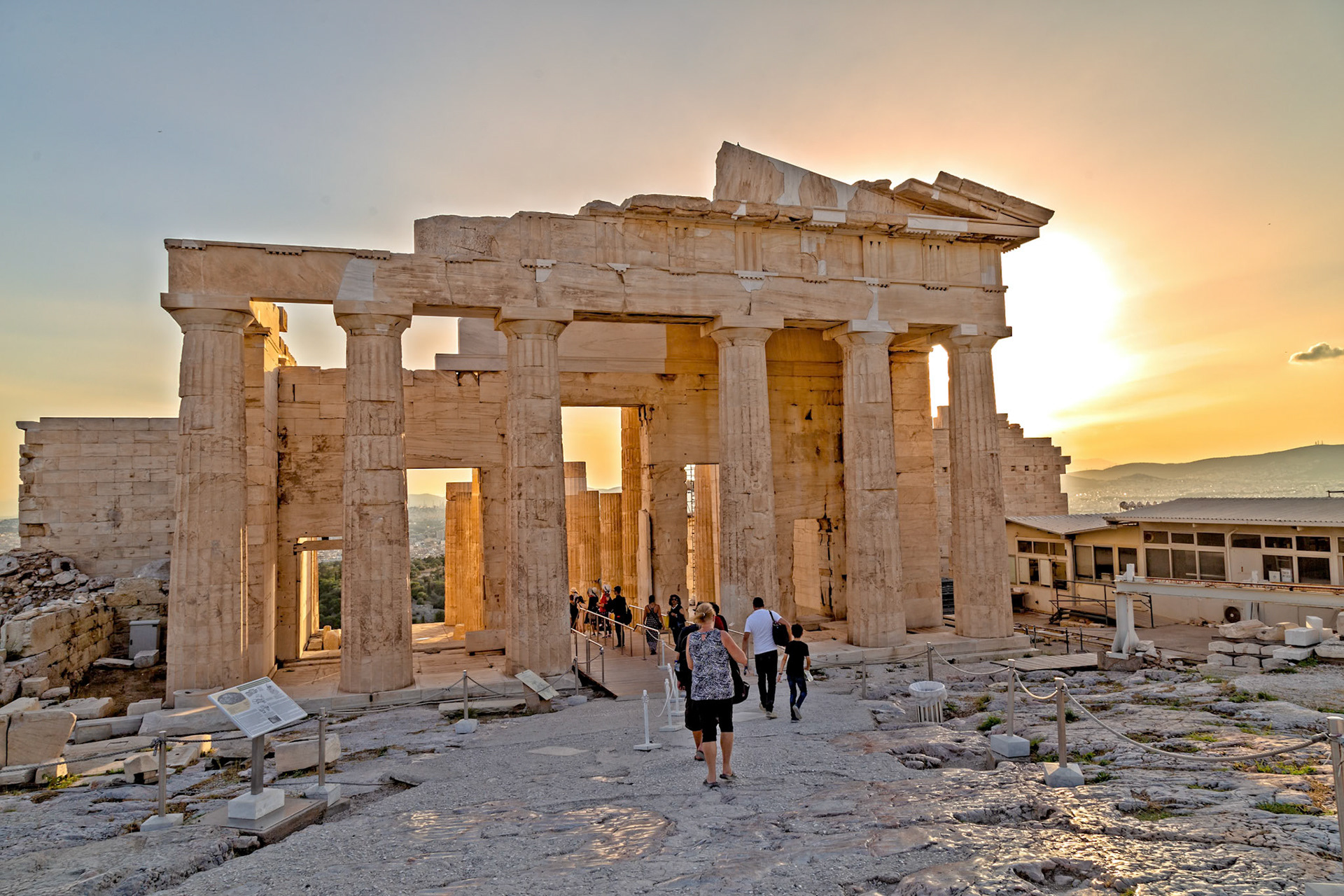 Acropolis, Athens, Greece - May 23rd 2018: Tourists explore the Erechtheion temple, a historic landmark, during sunset, capturing its beauty and history.